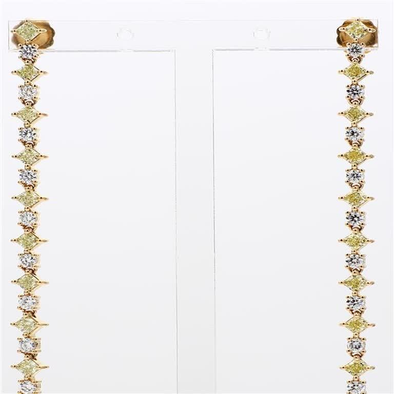 RareGemWorld's classic natural radiant cut yellow diamond earrings. Mounted in a beautiful 18K Yellow Gold setting with natural radiant cut yellow diamonds. The yellow diamonds are surrounded by small round natural white diamond melee. These