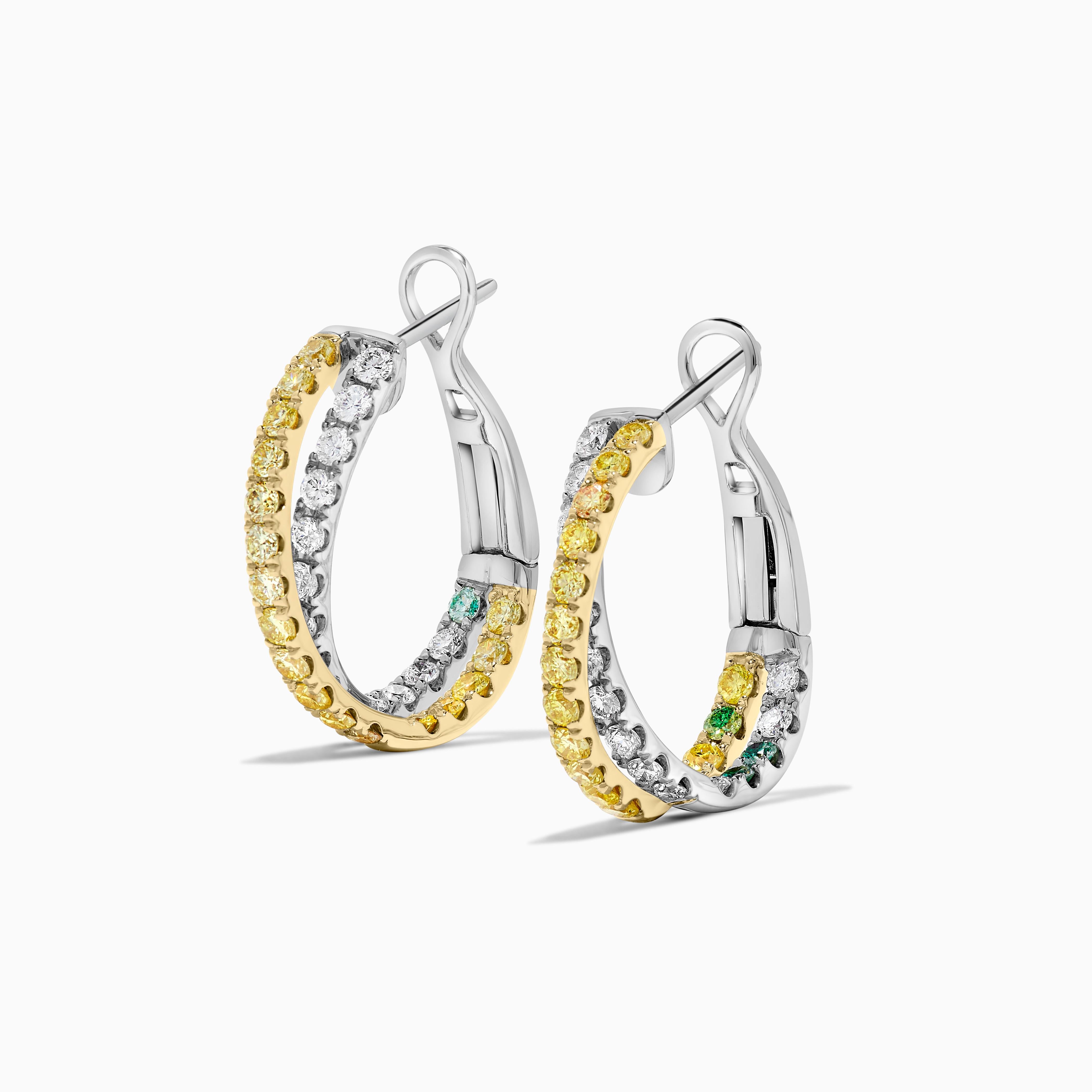 RareGemWorld's classic natural round cut diamond earrings. Mounted in a beautiful 18K Yellow and White Gold setting with natural round yellow diamond melee and natural round white diamond melee in a beautiful interlocking circle form. These earrings