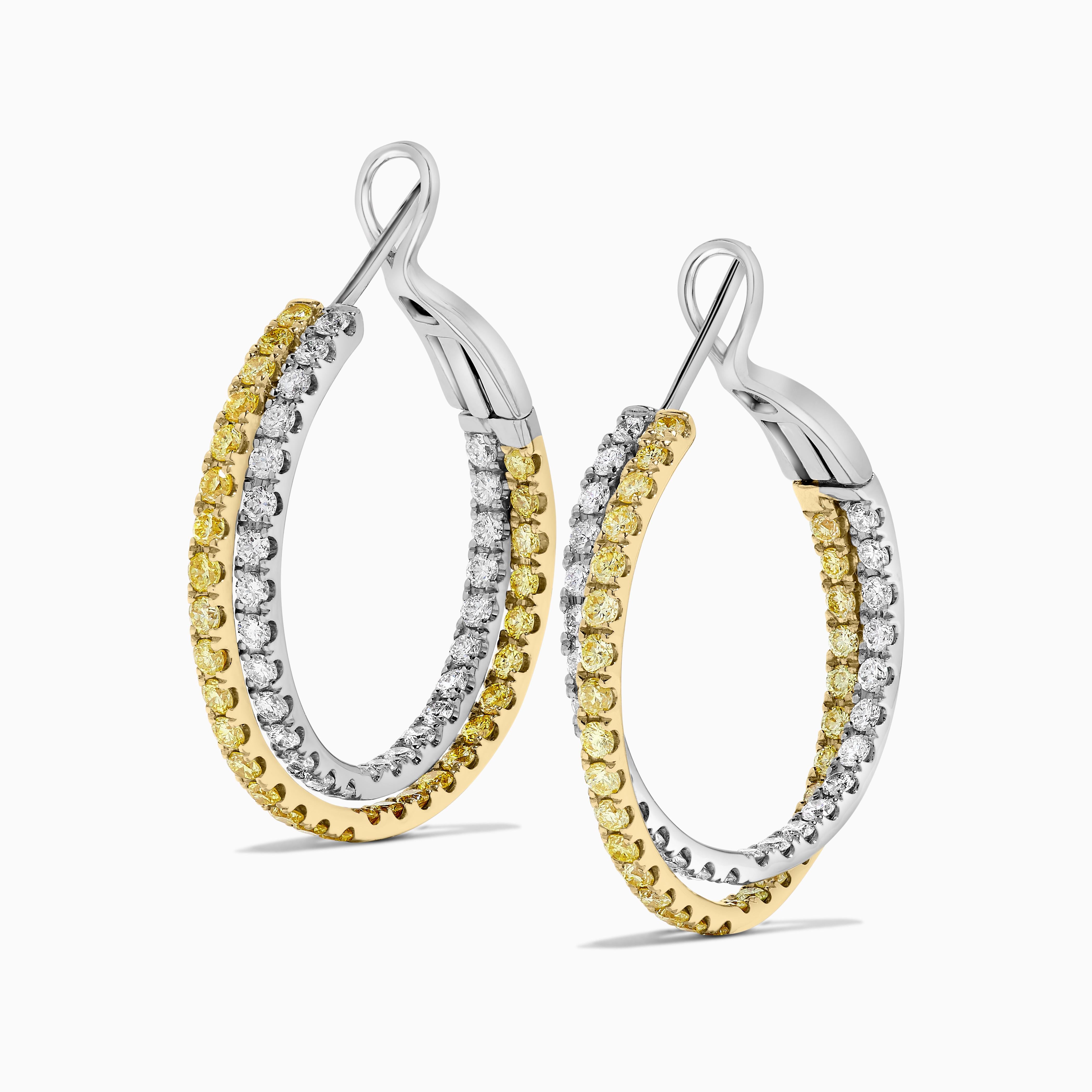 RareGemWorld's classic natural round cut diamond earrings. Mounted in a beautiful 18K Yellow and White Gold setting with natural round cut yellow diamonds. These earrings include both natural round yellow diamond melee and natural round white
