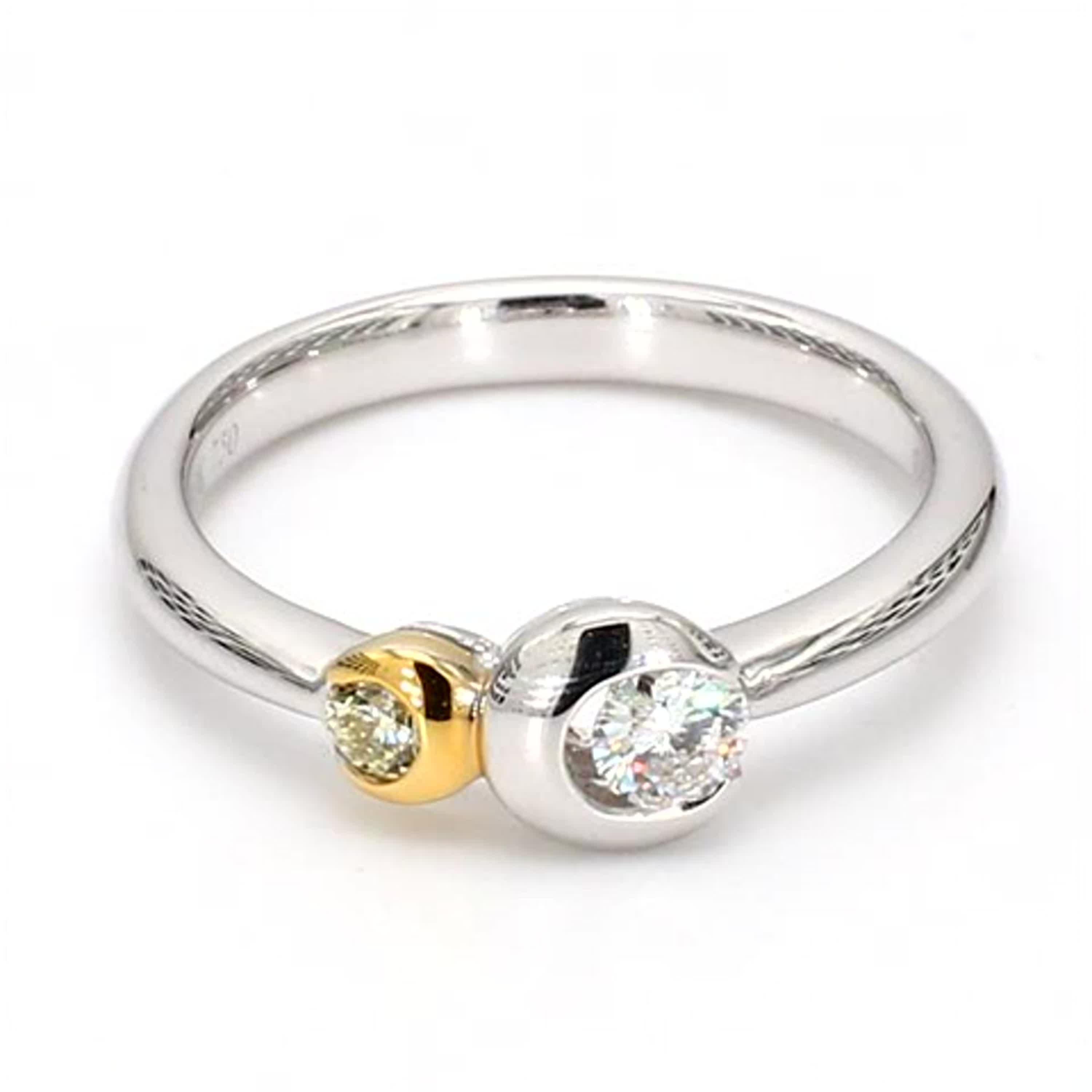 RareGemWorld's classic diamond band. Mounted in a beautiful 18K Yellow and White Gold setting with a natural round cut yellow diamond complimented by a natural round cut white diamond. This band is guaranteed to impress and enhance your personal