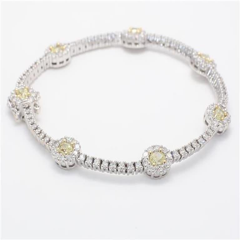 RareGemWorld's classic diamond bracelet. Mounted in a beautiful 18K Yellow and White Gold setting with 7 natural oval cut yellow diamonds. The yellow diamonds are surrounded by small round natural white diamond melee as well as diamonds continuing