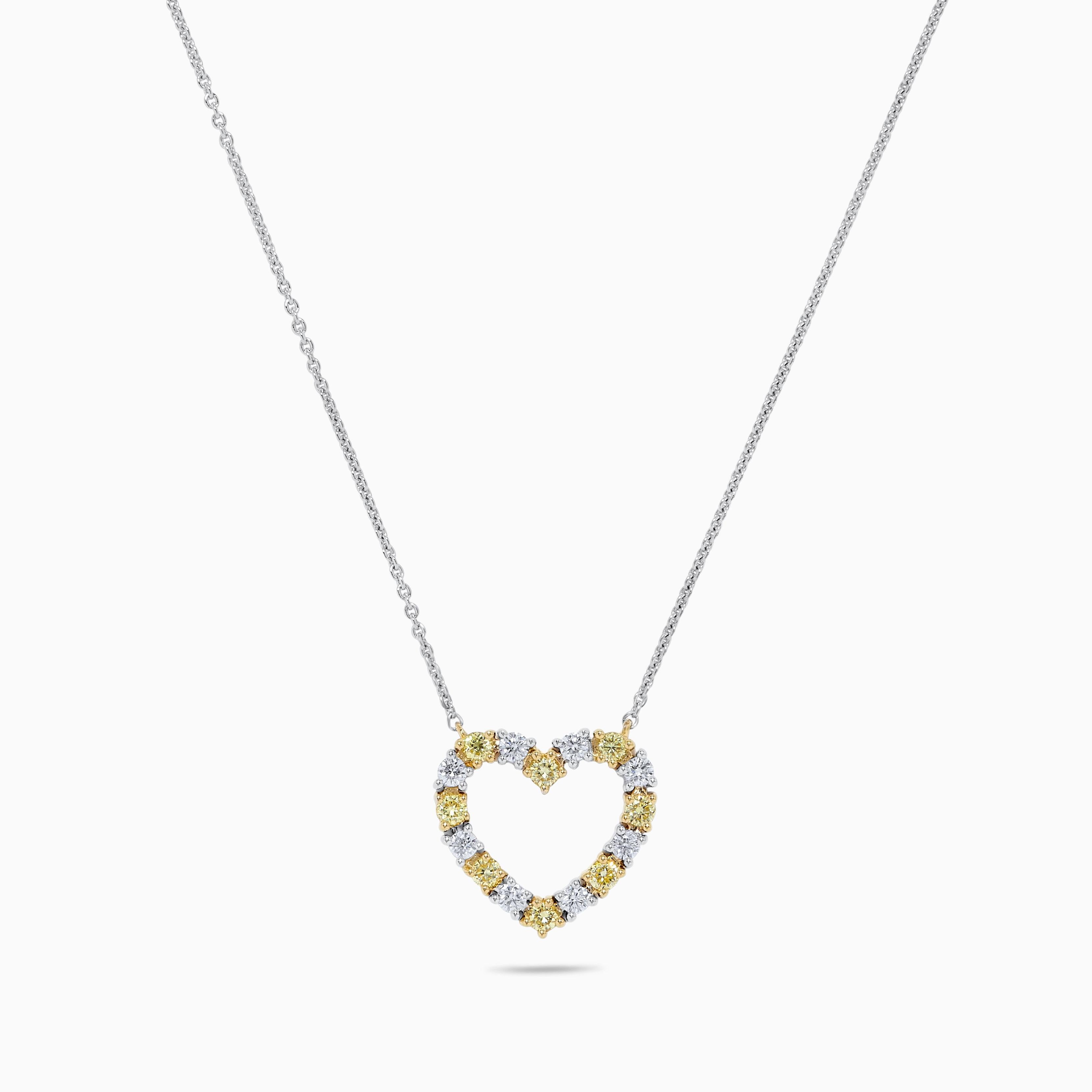 RareGemWorld's classic diamond necklace. Mounted in a beautiful 18K Yellow and White Gold setting with natural round yellow diamond melee complimented by natural round white diamond melee in a beautiful heart shape. This necklace is guaranteed to