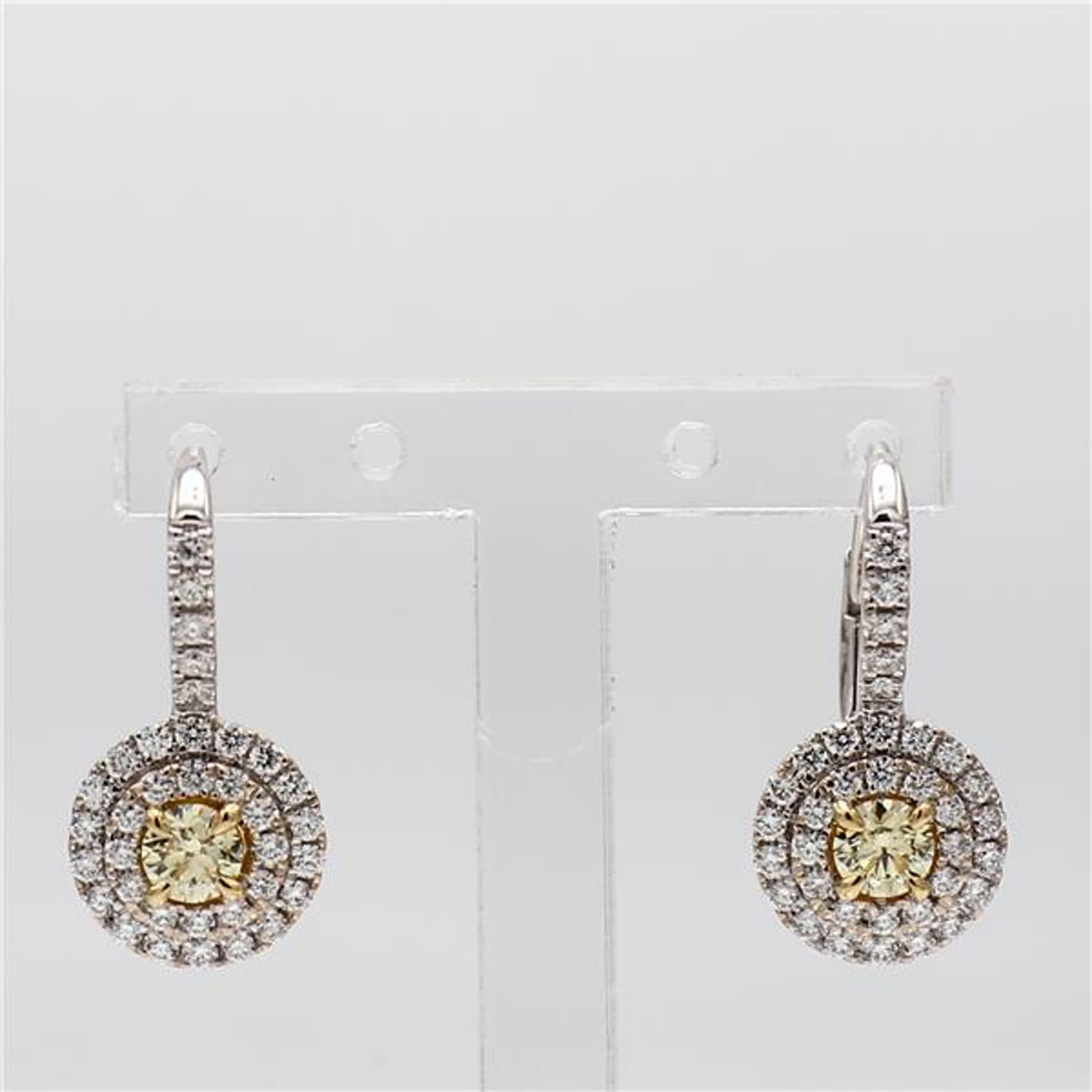 RareGemWorld's classic diamond earrings. Mounted in a beautiful 18K Yellow and White Gold setting with natural round cut yellow diamonds. The yellow diamonds are surrounded by small round natural white diamond melee in a beautiful double halo. These