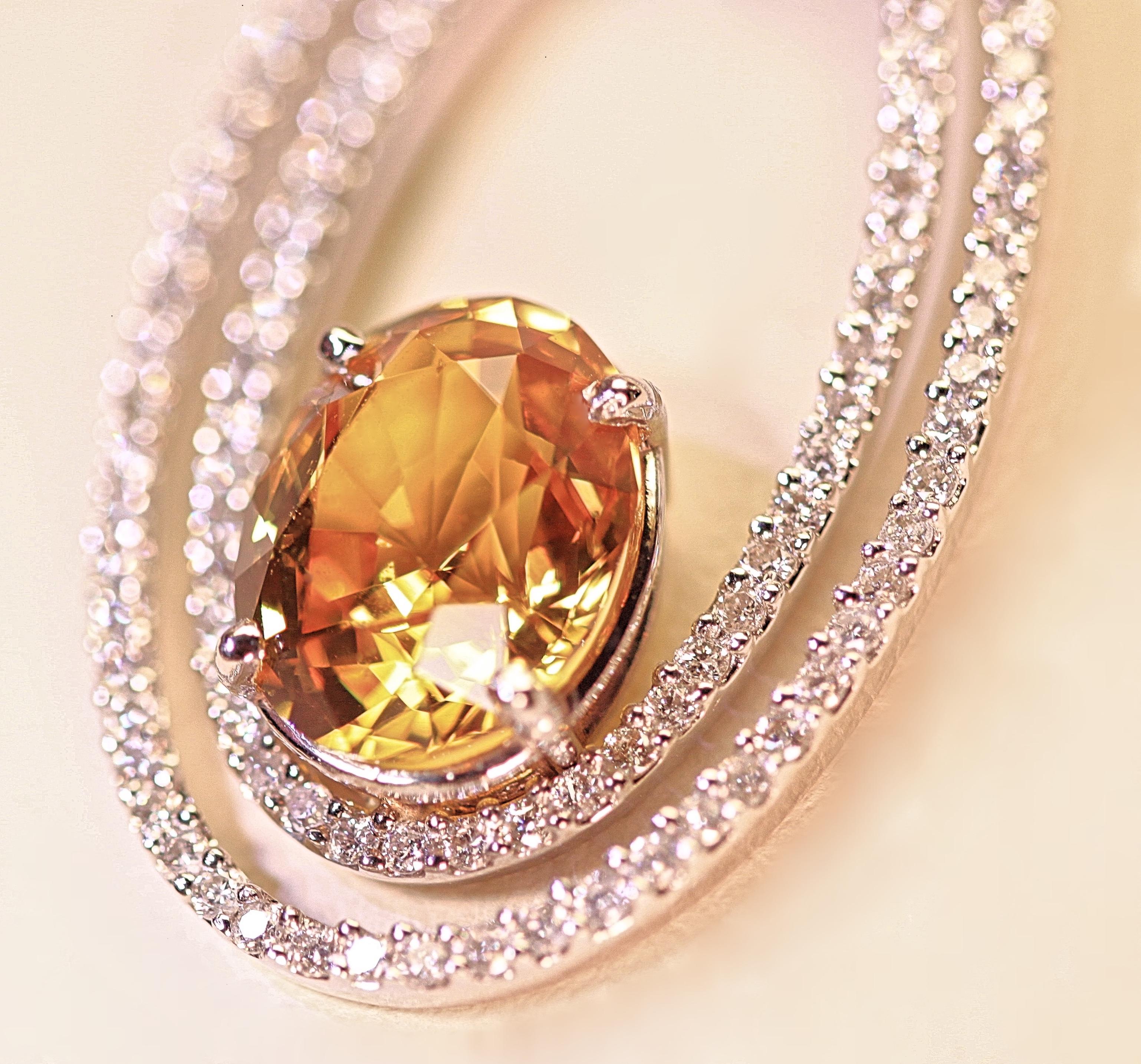 A beautiful natural yellow sapphire enhanced by classy diamond oval circles.  The yellow sapphire has an AGL certificate grading it a natural stone that has not been heat enhanced.  The yellow sapphire weighs 4.05 carats total and the diamonds weigh