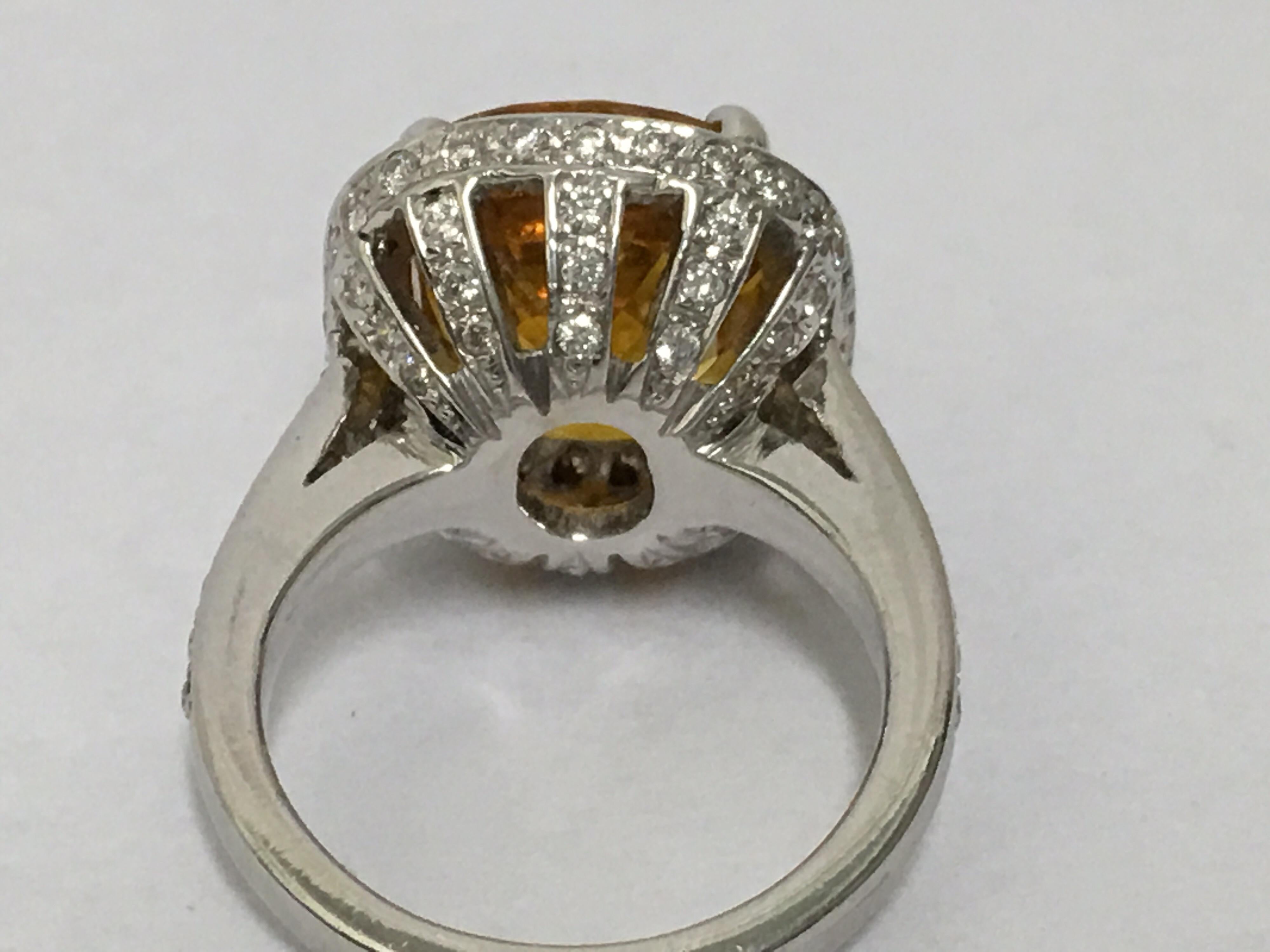 Yellow sapphire is 5.11 Carat and approx 1.5 Carat  diamonds set in 18 K white gold.
The Ring is one of a kind. 
Size is 6.5 but can be resized.
 