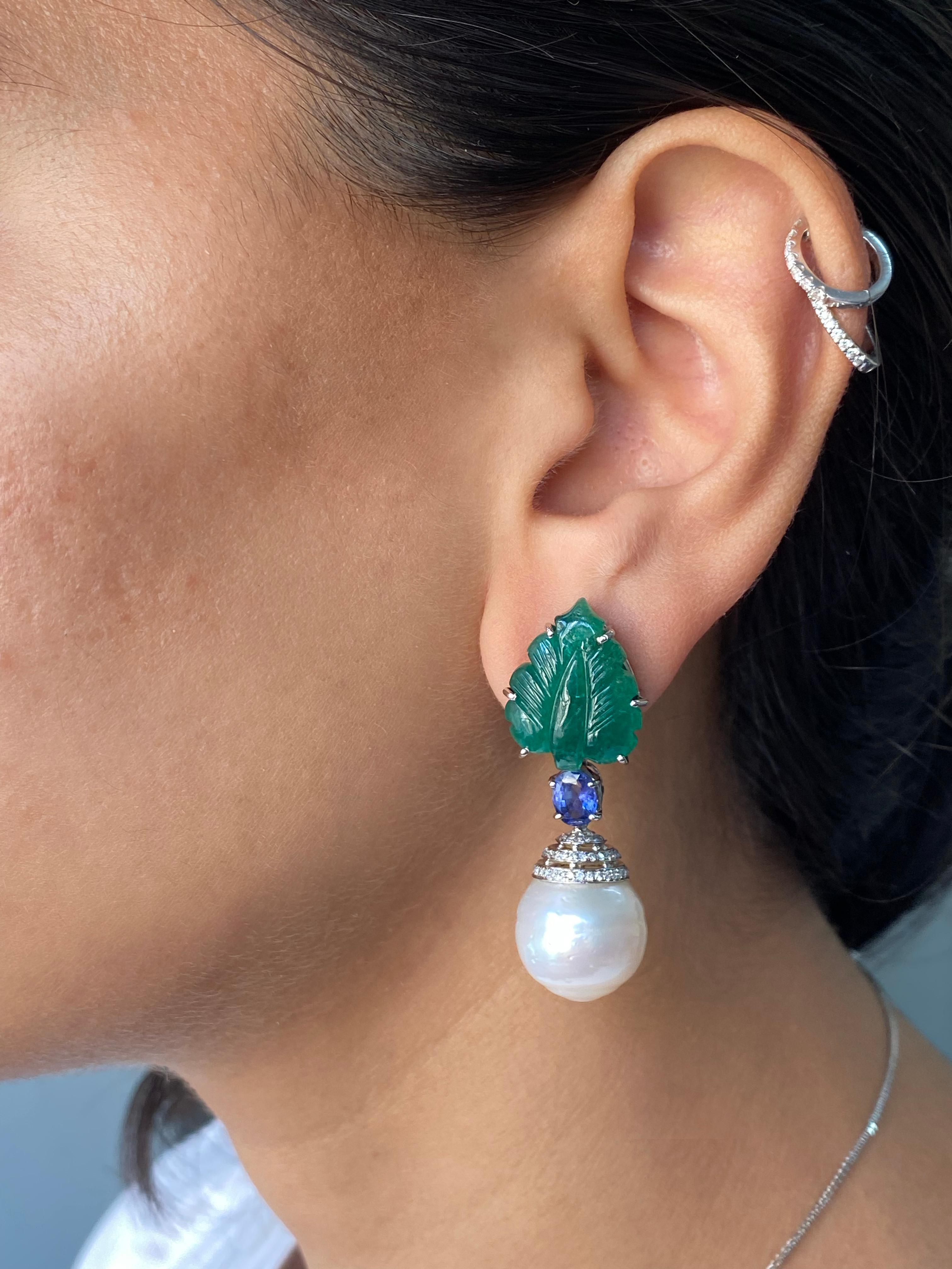 These are a pair of natural 17 carats, hand-carved, Zambian Emeralds with pair of South Sea Pearls and 1.6 carat Blue Sapphires hanging down to complete the look - all set in solid 18K White Gold. 

We offer free express shipping worldwide and