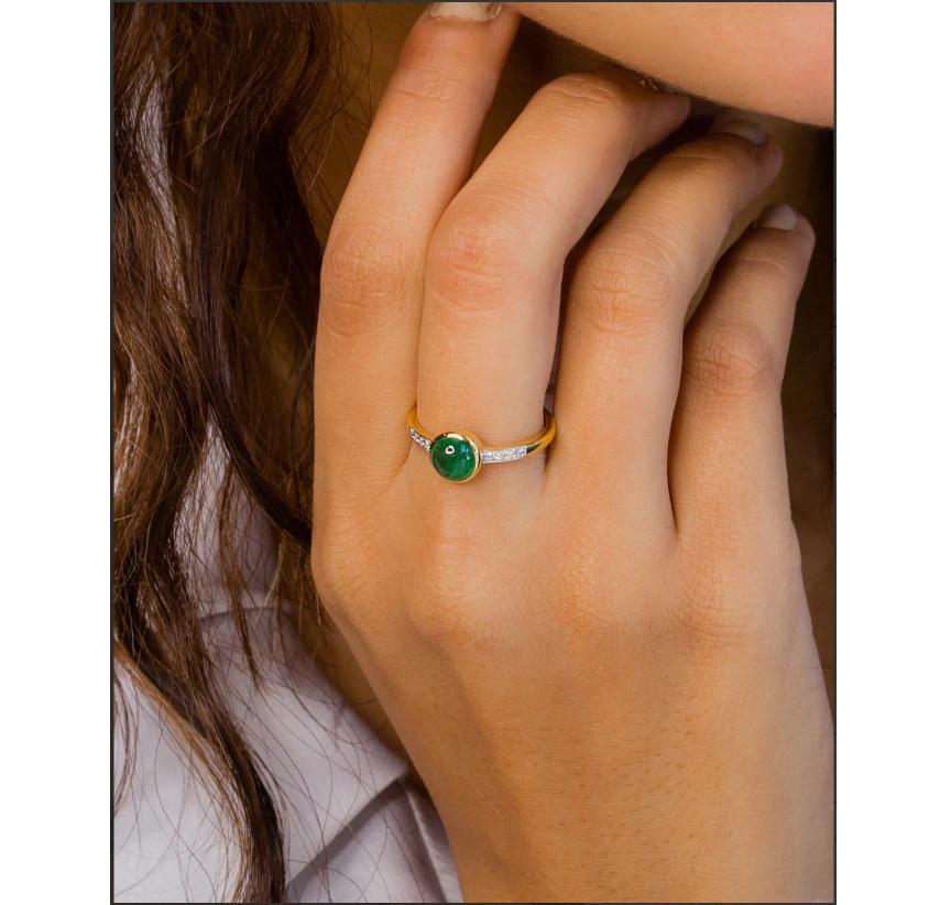 Handcrafted in 14K Solid Yellow Gold Natural Diamond (G-H Color, SI1-SI2 Purity) and 1.22 Carat Emerald Gemstone, with a gold bezel and luxurious appeal. The motif uses coloured emerald adding a beautiful contrast with the sheen yellow gold colour.