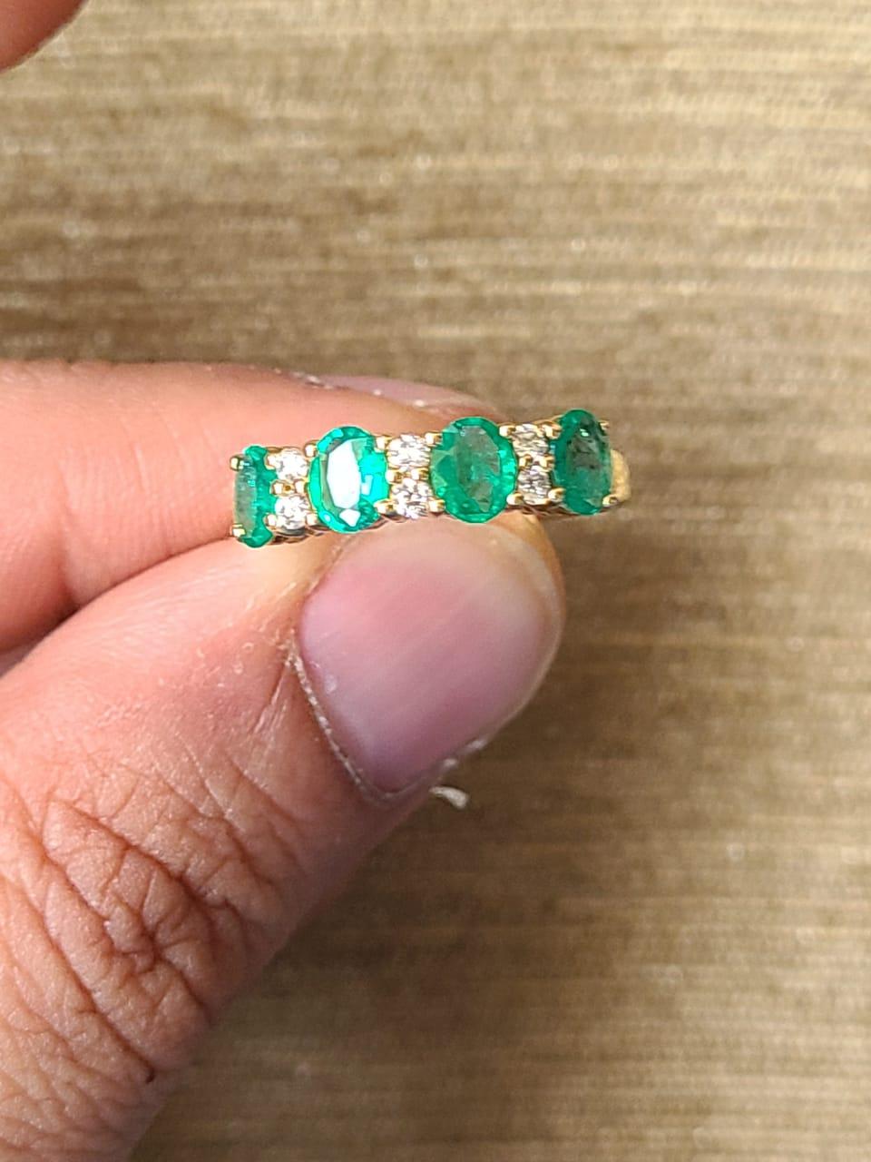 A very dainty and gorgeous Zambian Emerald Band / Wedding Ring set in 18K Yellow Gold & Diamonds. The weight of the Emeralds is 0.92 carats. The Emeralds are of Zambian origin, & is completely natural, without any treatment. The weight of the