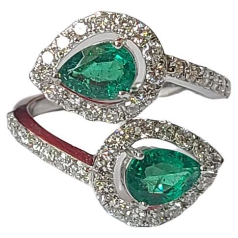 A very beautiful and chic Emerald Cocktail / Engagement Ring set in 18K White Gold & Diamonds. The weight of the Emeralds is 1.29 carats. The pear shaped Emeralds are completely natural, without any treatment and are of Zambian origin. The weight of