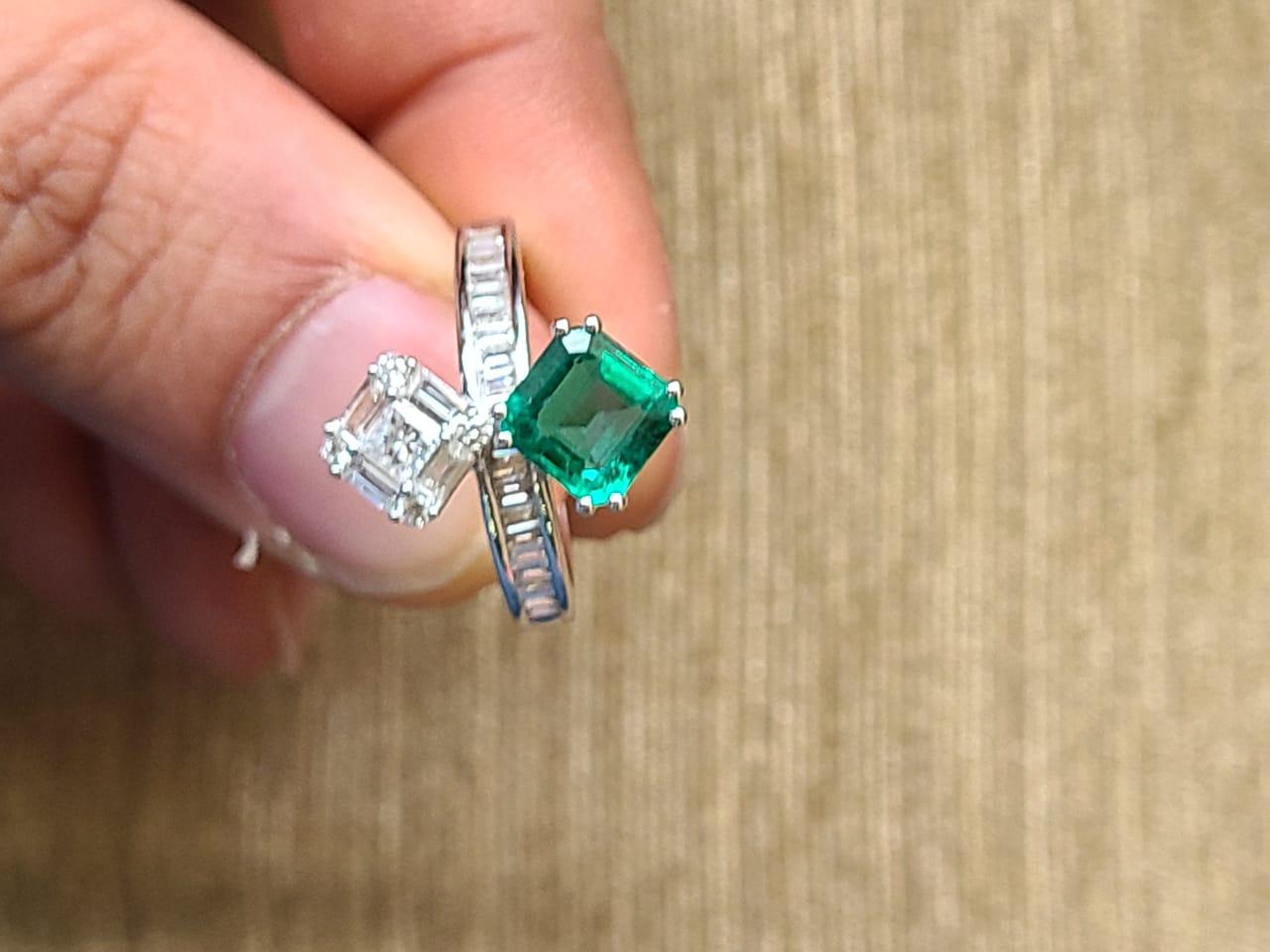 A very beautiful Emerald Engagement Toi et Moi Ring set in 18K White Gold & Diamonds. The weight of the Emerald is 1.28 carats. The Emerald is of very good quality and is of Zambian origin. The Emerald is completely natural, without any treatment.