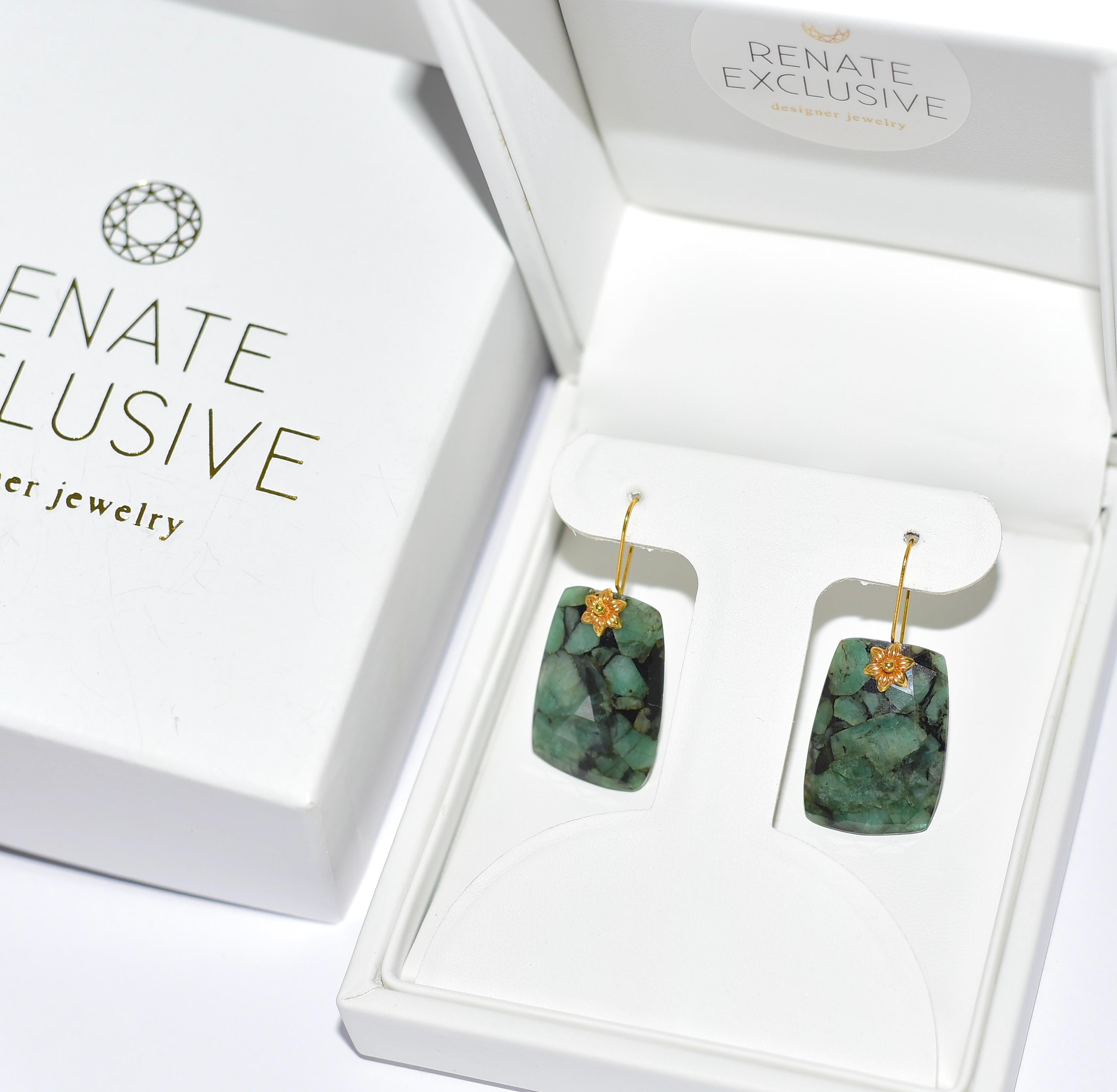 This is an untreated and impressive size pair of Zambian emerald in a lovely mix of semi-translucent hunter green with bold black mottling for a striking look. They are an asymmetrical rectangle shape.  The earrings look opulent the deep green color