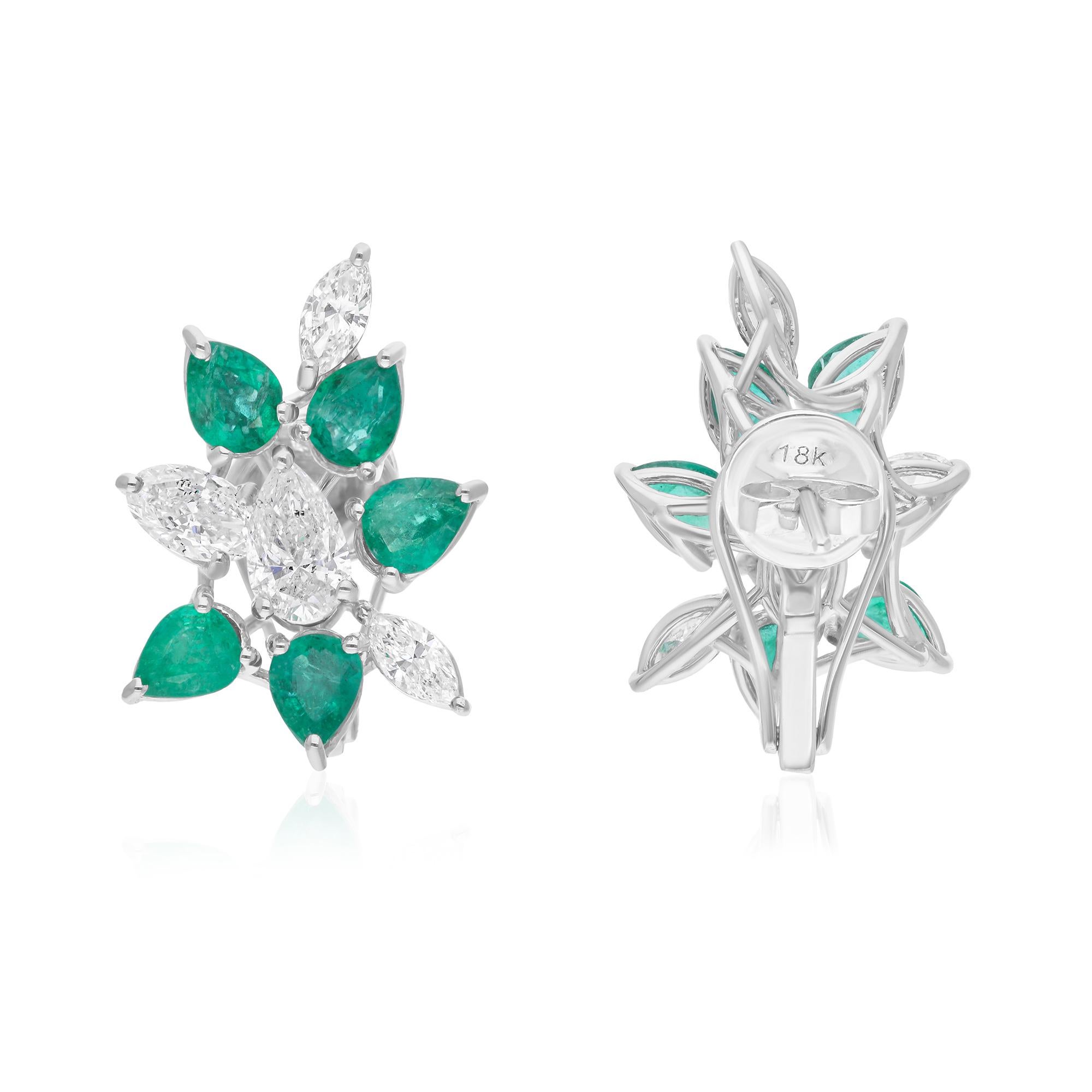 These elegant earrings feature natural Zambian emeralds set in 18 karat white gold, accented by a sparkling array of brilliant diamonds. The vivid green of the 2.90 carat Zambian emeralds contrasts beautifully with the brilliance of 2.26 carats of