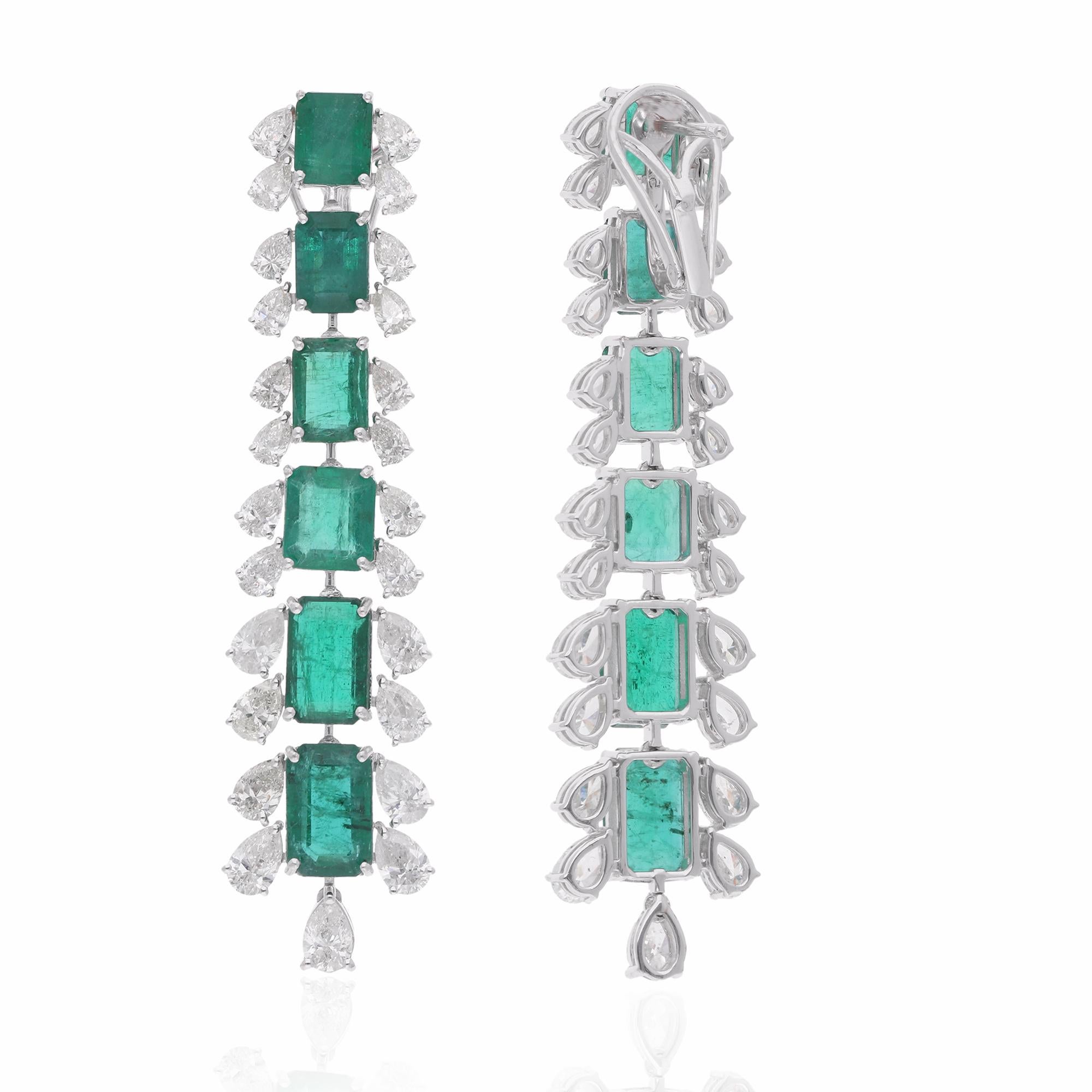 Immerse yourself in the timeless elegance of these Natural Zambian Emerald Gemstone Dangle Earrings, adorned with dazzling Diamonds and meticulously crafted in luxurious 18 Karat White Gold. These exquisite earrings are a celebration of
