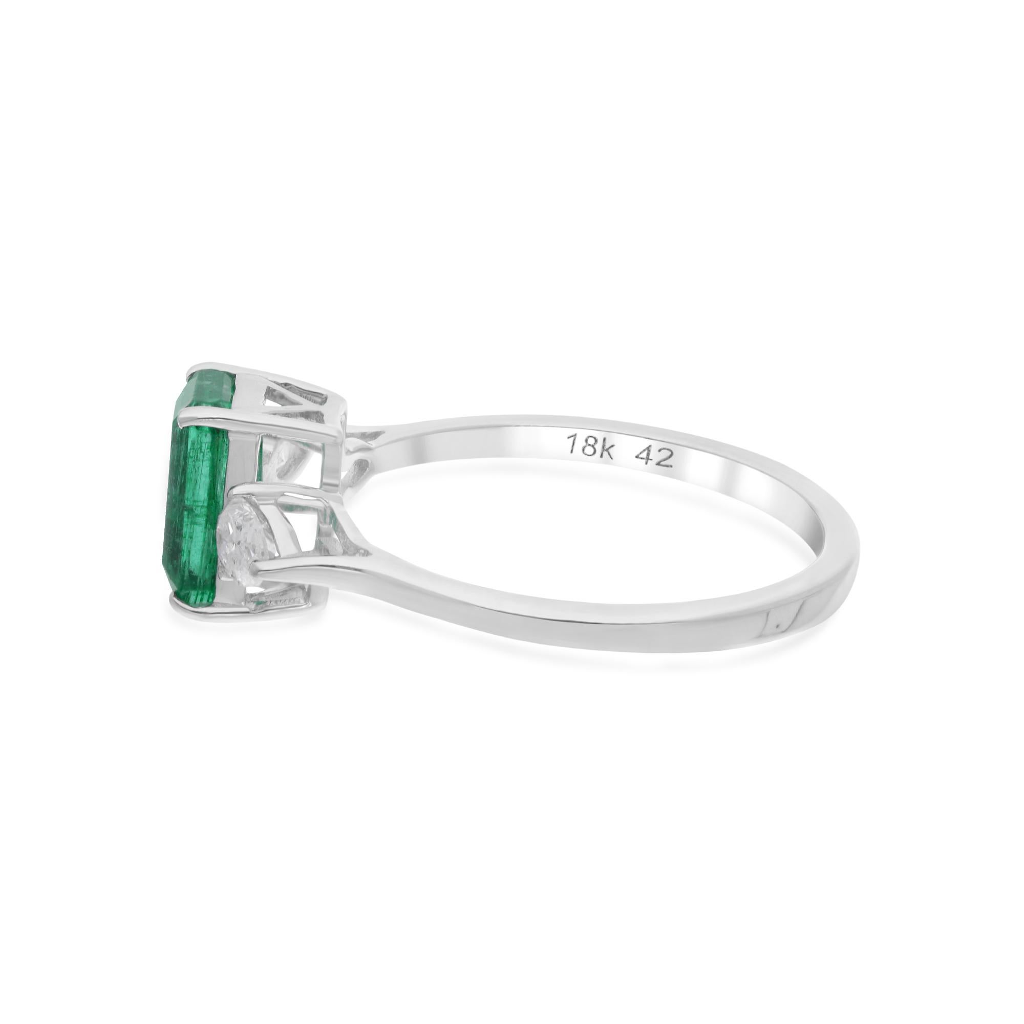 At the center of the ring glimmers a mesmerizing Zambian emerald gemstone, prized for its vivid green hue and exceptional clarity. Sourced from the prestigious mines of Zambia, each emerald exudes a natural beauty and allure that captivates the eye.