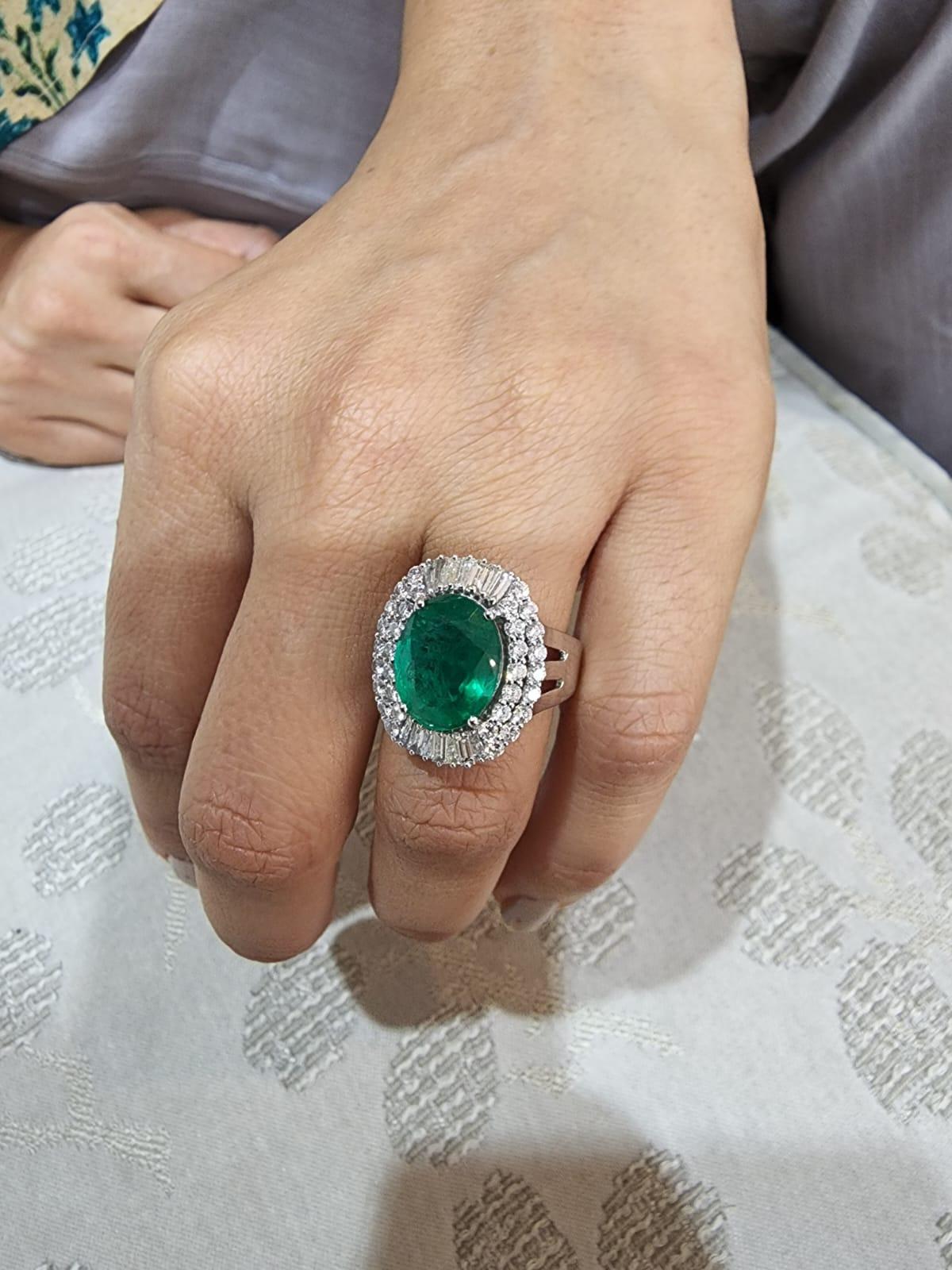 This is a natural Zambian Emerald ring with diamonds and 14k gold. the emeralds are of very high quality and very good quality diamonds. the clarity is ( vsi) and colour is G 

emeralds : 4.54 CT’s
diamond : 1.47 CT’s
gold : 7.39 gems
It’s very hard