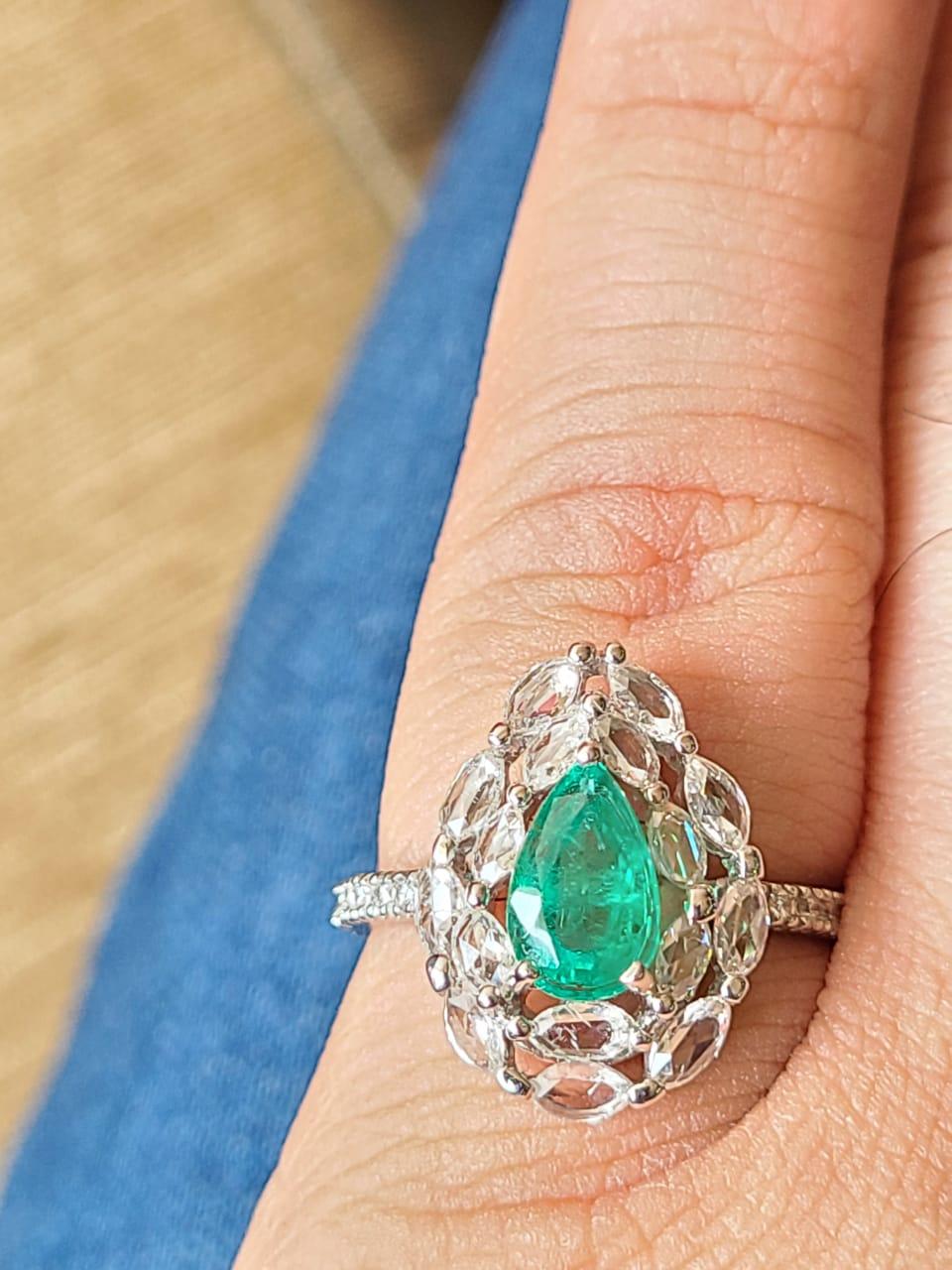 A very gorgeous and wearable Emerald Engagement Ring set in 18K White Gold & Diamonds. The weight of the Pear shaped Emerald is 1.01 carats. The Emerald is of Zambian origin and is completely natural without any treatment.  The weight of the Rose
