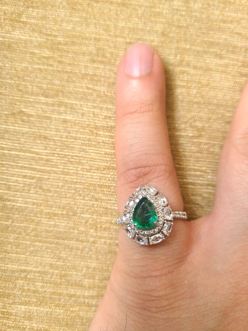 A very gorgeous and one of a kind Emerald Engagement/ Cocktail Ring set in 18K White Gold & Diamonds. The weight of the Emerald is 0.96 carats. The Emerald is completely natural, without any treatment & is of Zambian origin. The combined weight of
