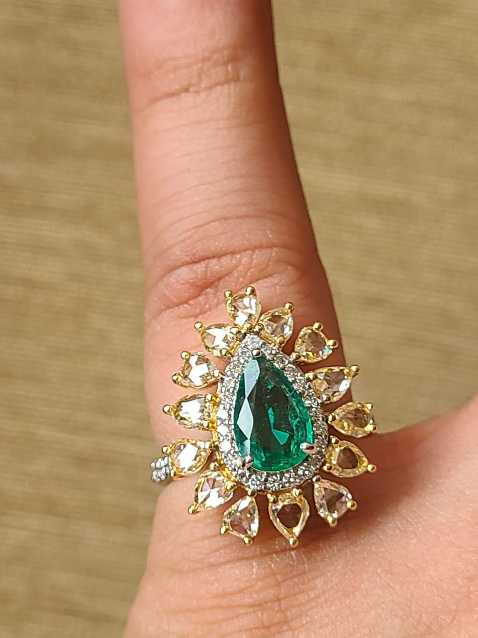 A very beautiful and wearable Emerald Engagement Ring set in 18K Gold & Diamonds. The weight of the Zambian Emerald is 0.88 carats. The Emerald is completely natural, without any treatment and is of Zambian origin. The weight of the Rose Cut