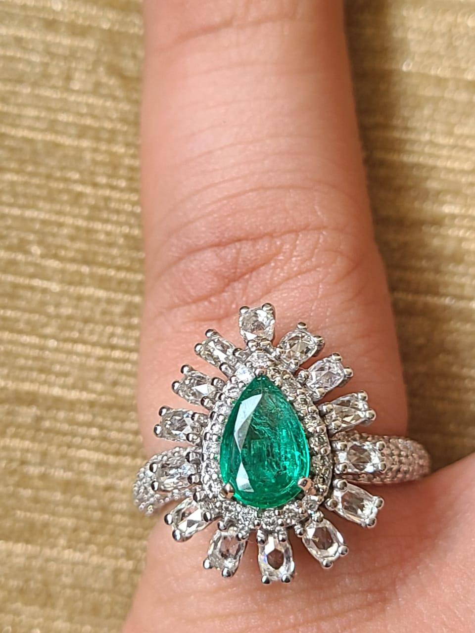 A very beautiful and one of a kind, Emerald Engagement Ring set in 18K White Gold & Diamonds. The weight of the Emerald us 0.87 carats. The pear shaped Emerald is completely natural, without any treatment and is of Zambian origin. The weight of the