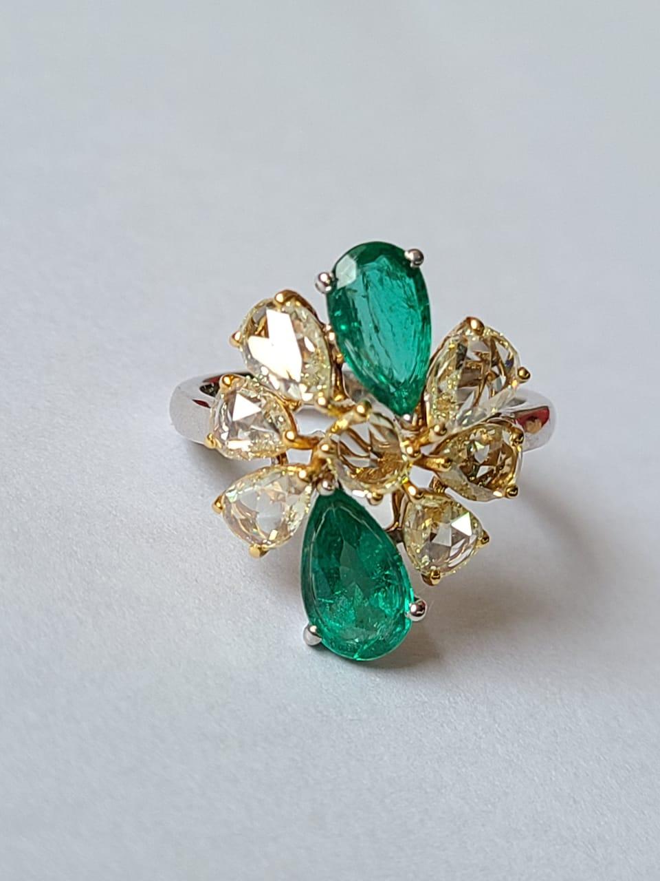 A very beautiful and one of a kind, Emerald Cocktail Ring set in 18K Gold & Diamonds. The weight of the pear shaped Emeralds is 1.79 carats. The Emeralds are completely natural, without any treatment and are of Zambian origin. The weight of the