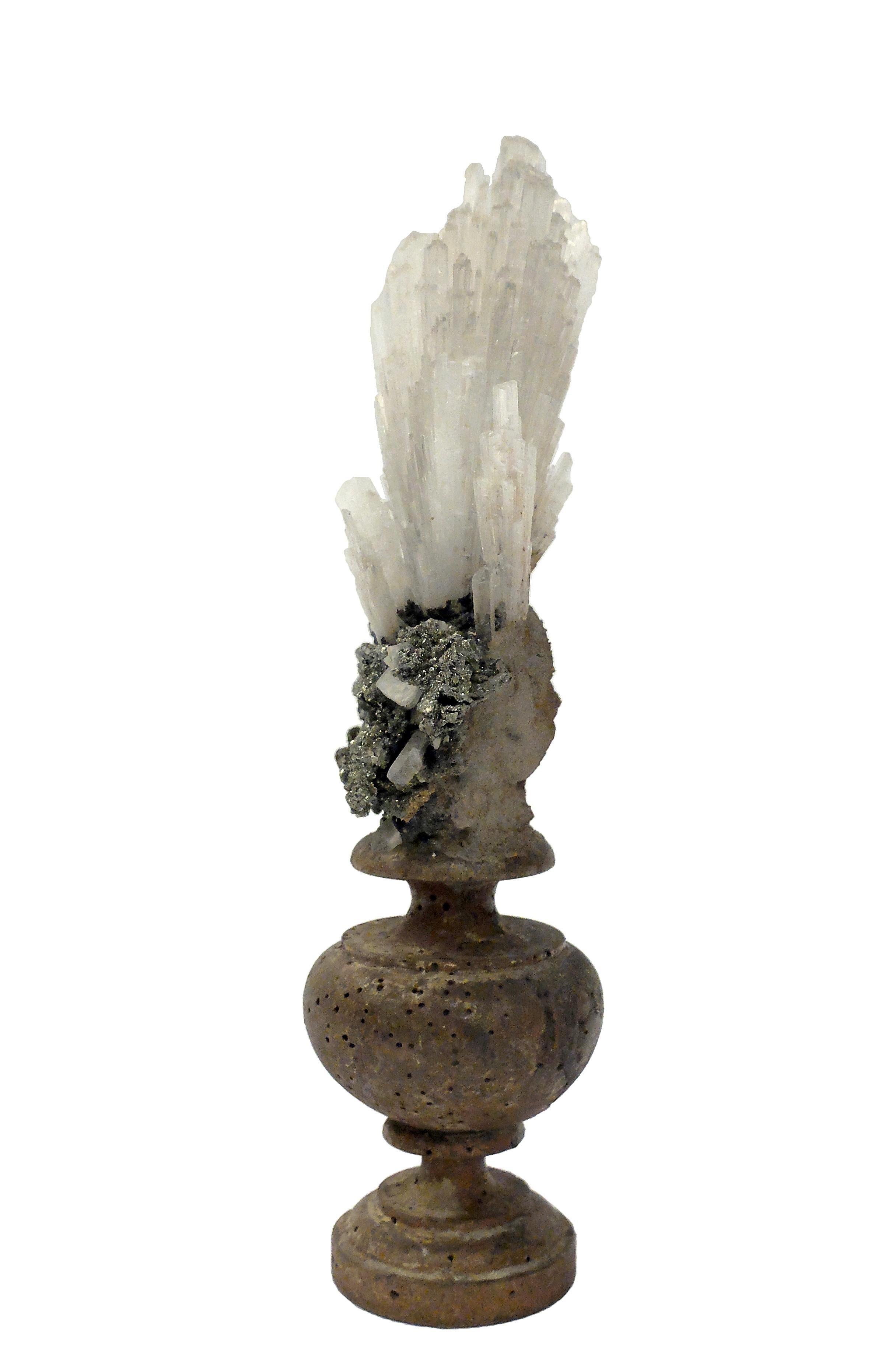 A Naturalia mineral specimen: A composition with Scolecite and Pyrite crystals, mounted over a guild plated wooden base on a vase shape.
