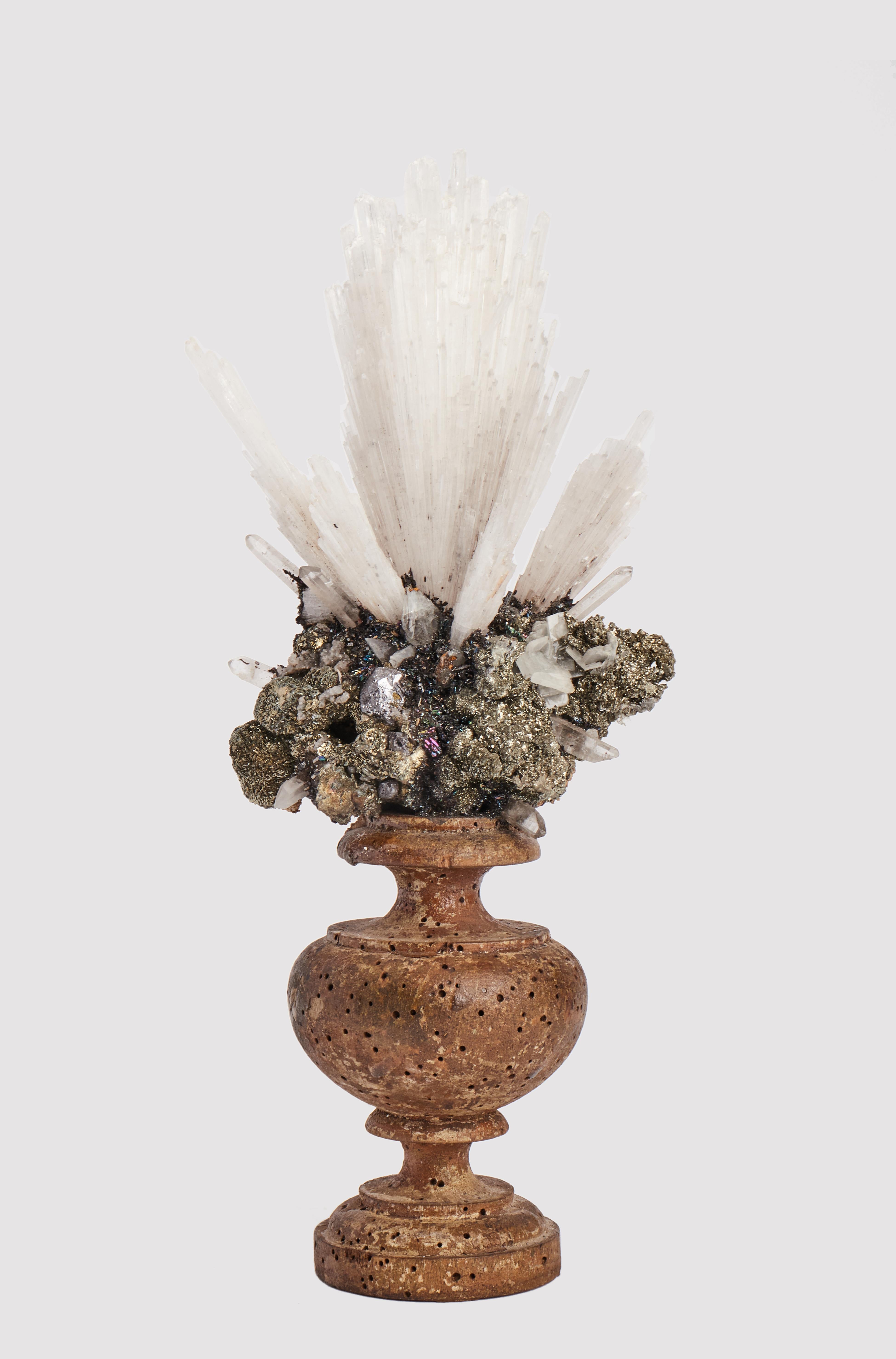A Naturalia mineral specimen: A composition with Scolecite and pyrite crystals, mounted over a guild-plated wooden base on a vase shape.