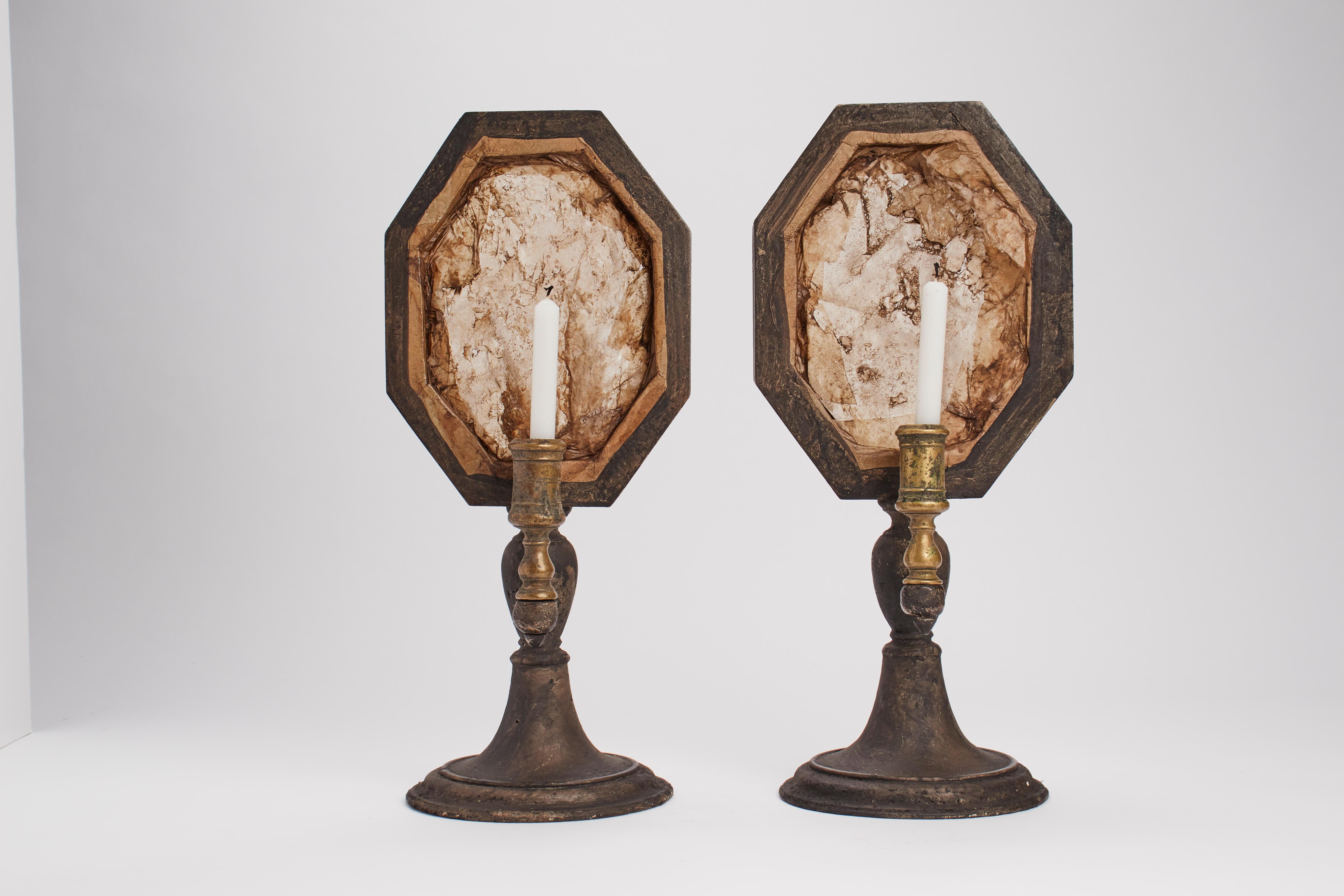 A Wunderkammer naturalia pair of rock crystals specimens octagonal shape with black wooden frames, mounted over black wooden bases, with candle holders, Italy, 1880 ca.