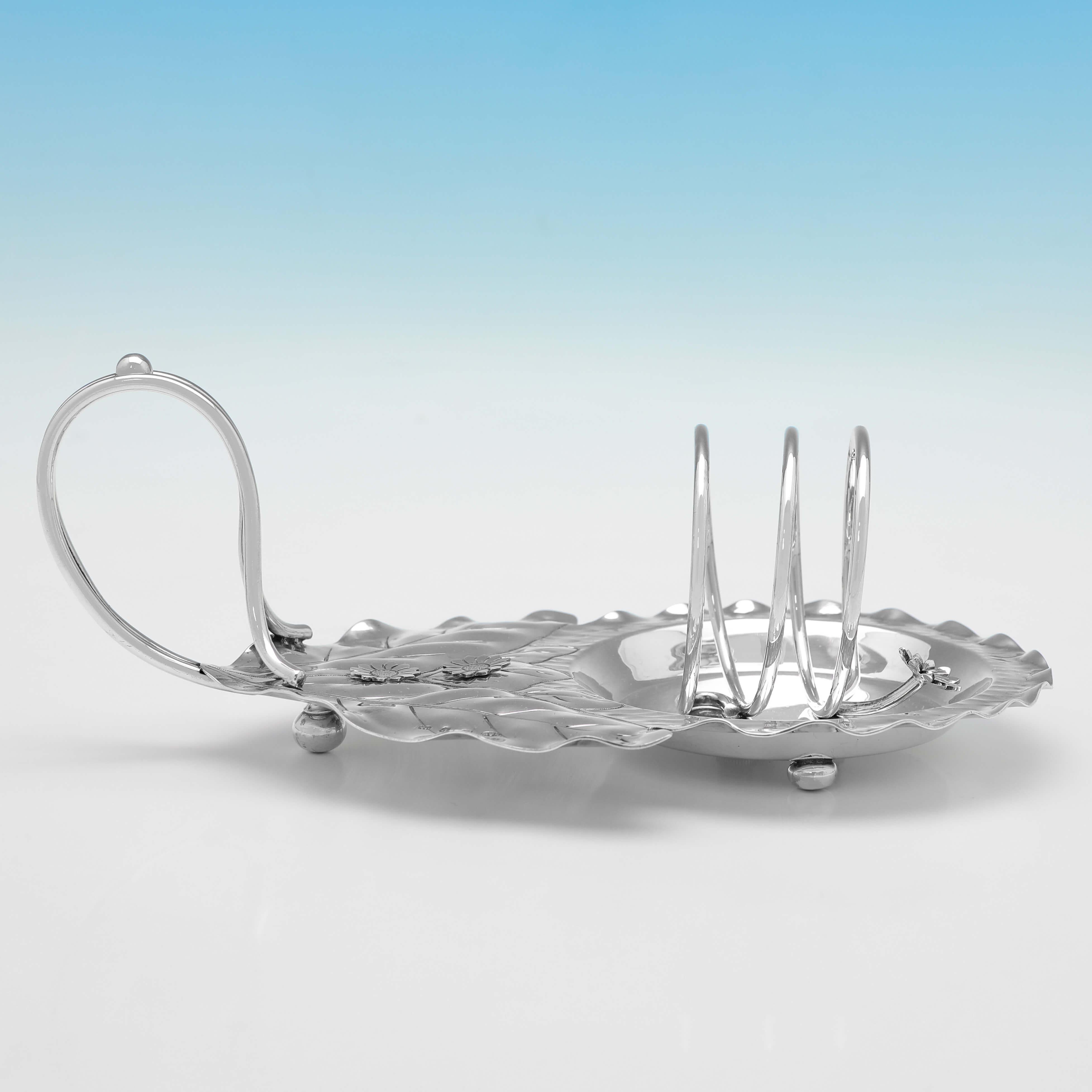 Hallmarked in Birmingham in 1898 by Norton & White, this charming, Victorian, Antique Sterling Silver Toast Rack, will hold 2 pieces of toast, and is designed to look like it is resting on a leaf. 

The toast rack measures 3.5
