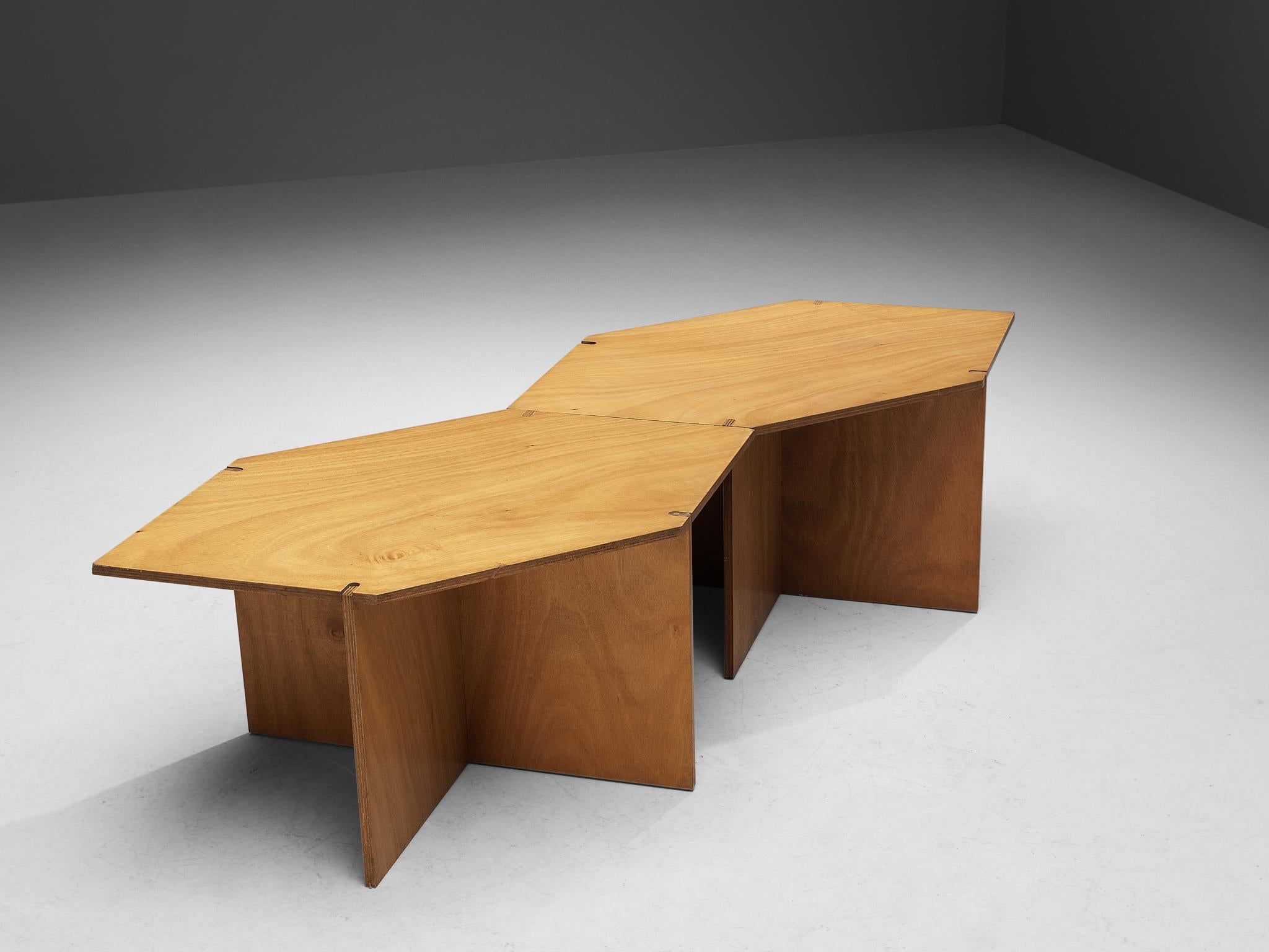 Coffee tables, walnut, Europe, 1980s

The top features a hexagonal shape with sharp angles and rests on a cruciform base. Another characteristic that enhances the table's constructive appearance are the visible wood joints. The walnut shows