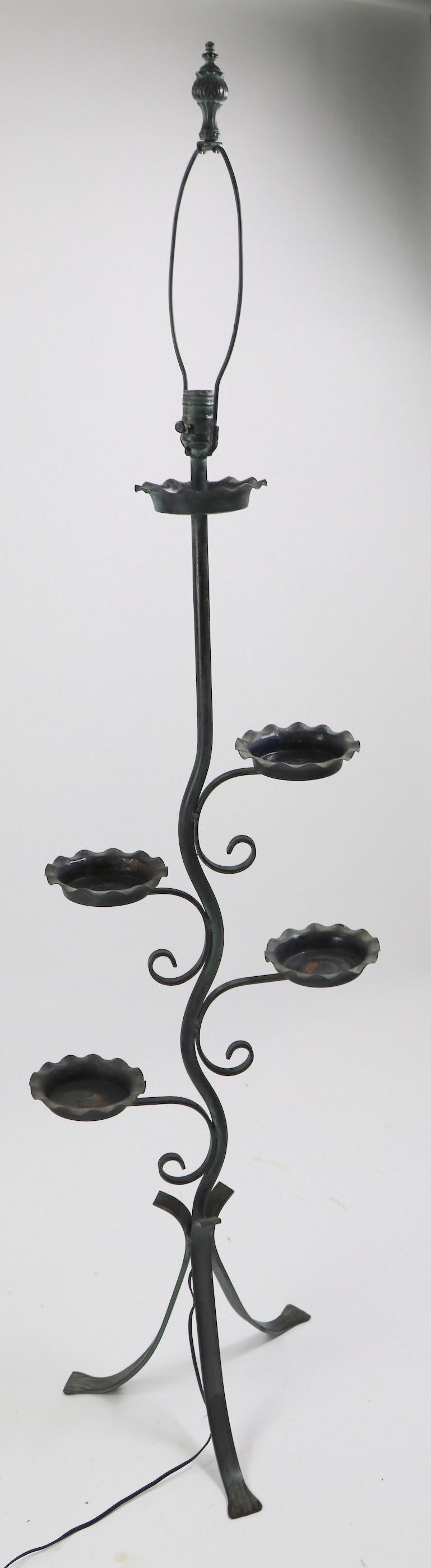 Stylish wrought and cast iron floor lamp, plant stand, in original faux verdigris finish. This interesting floor lamp has four arms, or branches, which support small ( 5.5 inch total diameter) trays, designed to hold a potted plant. The top is a