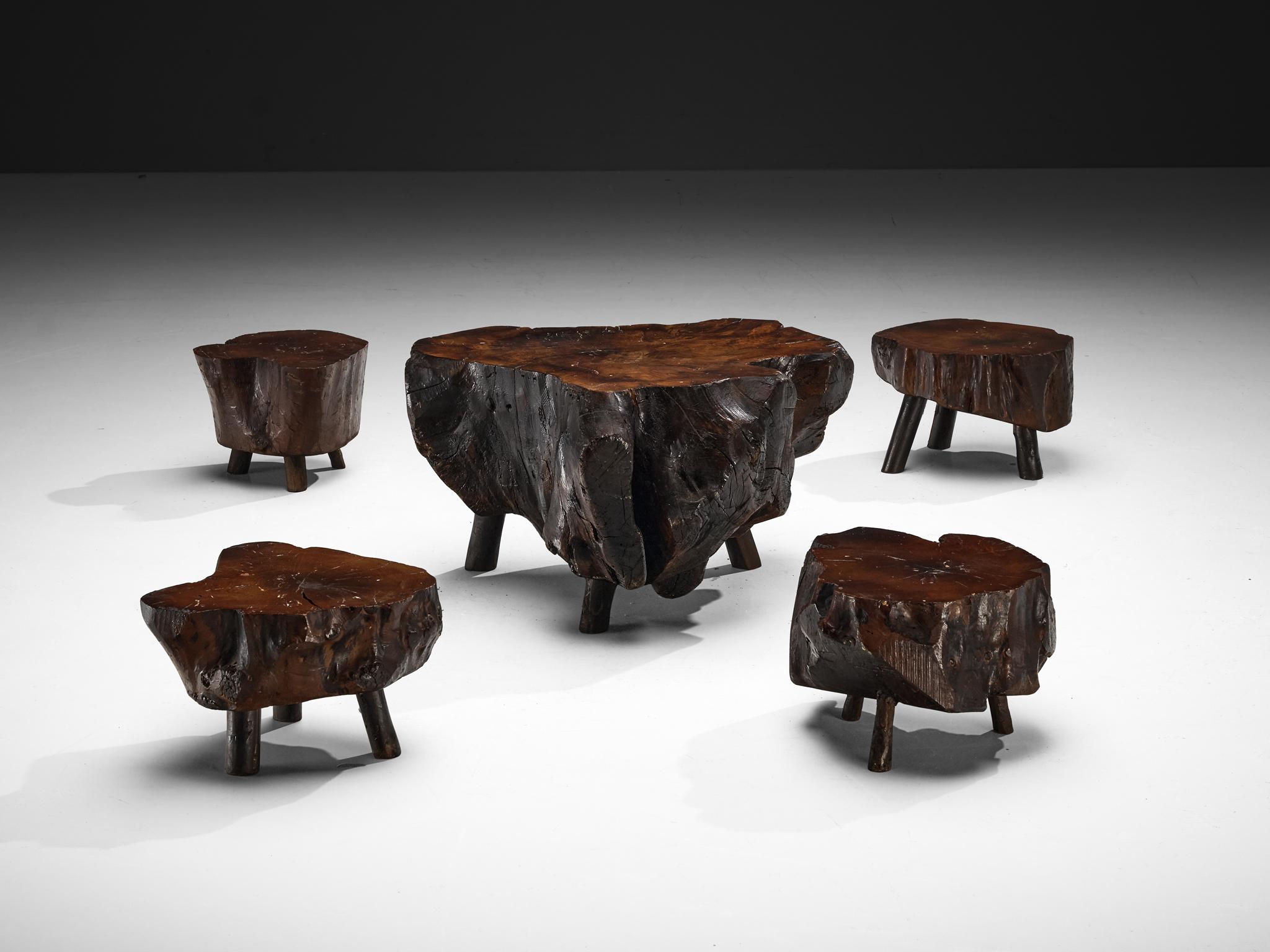 Low table with stools, solid slab of wood, Italy, 1960s

This remarkable low table and stools, crafted in Italy in the 1960s, stand as a testament to naturalistic design. Sculpted from single slabs of wood, their organic beauty is showcased in every