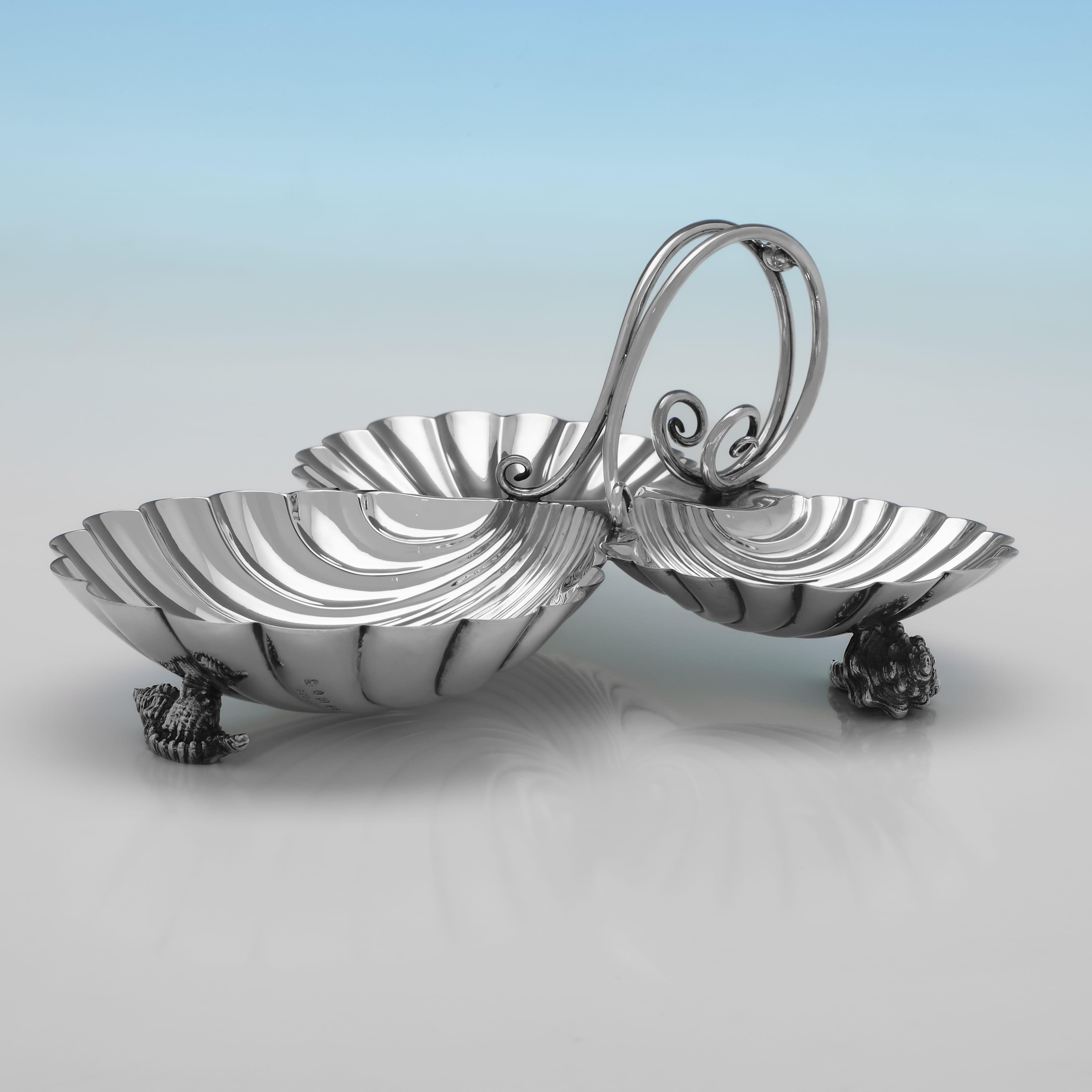 Hallmarked in Birmingham in 1892 by Elkington & Co., this attractive, Victorian, Antique Sterling Silver Dish, is shall shaped, standing on 3 cast shell feet, and with 3 sides and a vine shaped handle. The dish measures 5