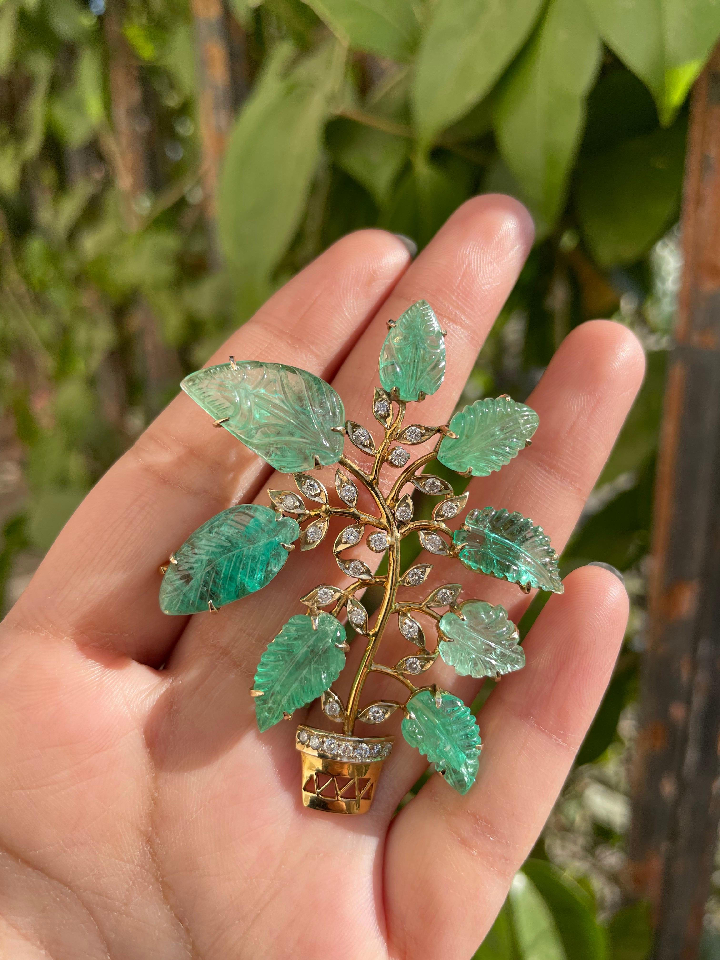 Nature Inspired 30 Carat Carved Emerald Brooch with Diamonds in 18K Yellow Gold which is a fusion of surrealism and pop-art, designed to make a bold statement. Crafted with love and attention to detail, this features 30 carats of emerald and 0.9
