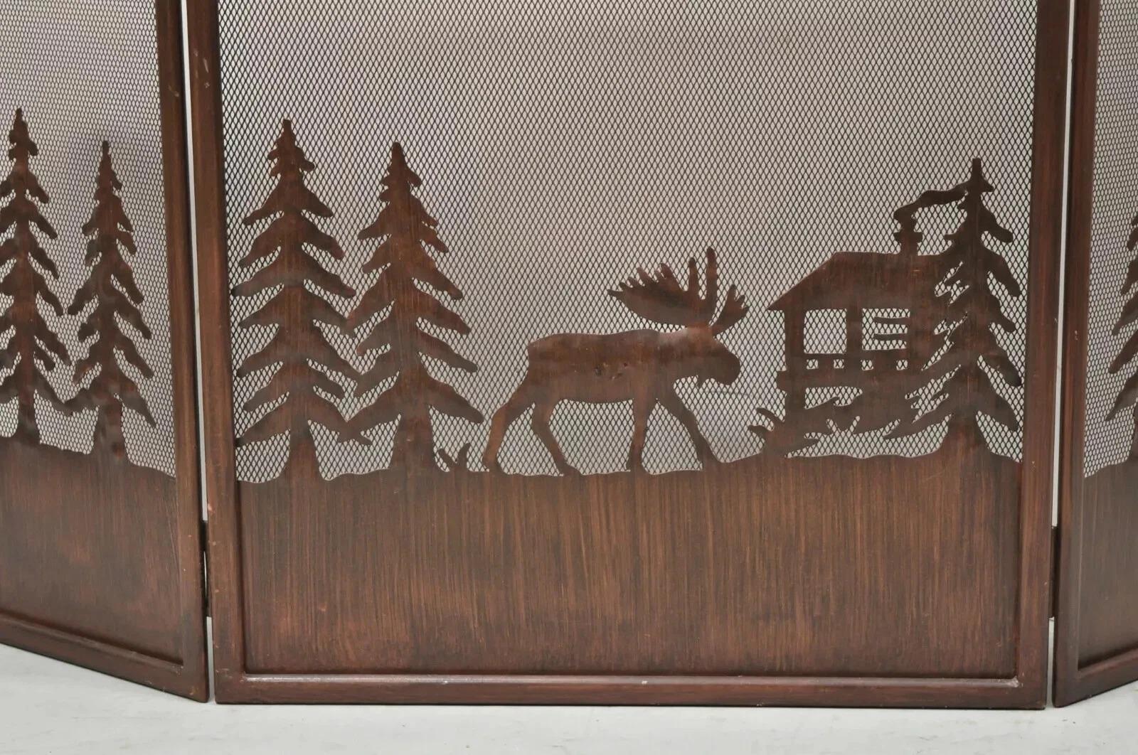 Nature Moose Wilderness Log Cabin Rustic Iron Metal Folding Fireplace Screen. Item features 3 section folding screen with wilderness scenes of tall trees, a moose, and log cabin. Circa Late 20th Century. Measurements: 30