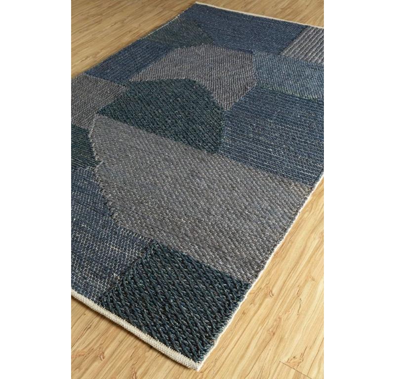 Like a modern masterpiece painted on the canvas of rural India, this handmade rug from brings nature's embrace into your space. Its flat weaves and geometric patterns, reminiscent of contemporary art, seamlessly blend with natural tones, presenting