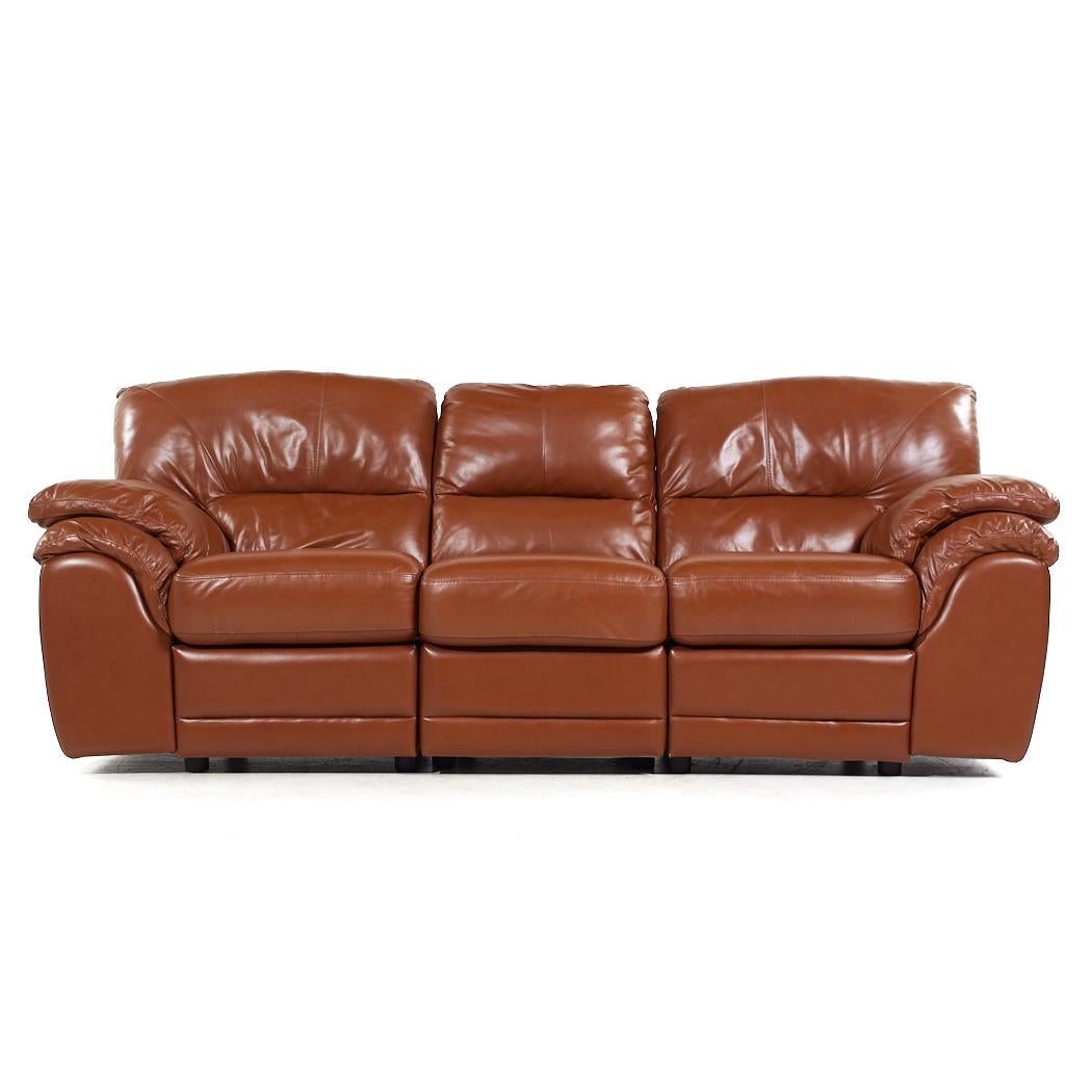 Natuzzi Style Brown Leather Modular Reclining Sofa

This sofa measures: 94 wide x 39 deep x 39 inches high, with a seat height of 20 and arm height of 26.5 inches

About Photos: We take our photos in a controlled lighting studio to show as much