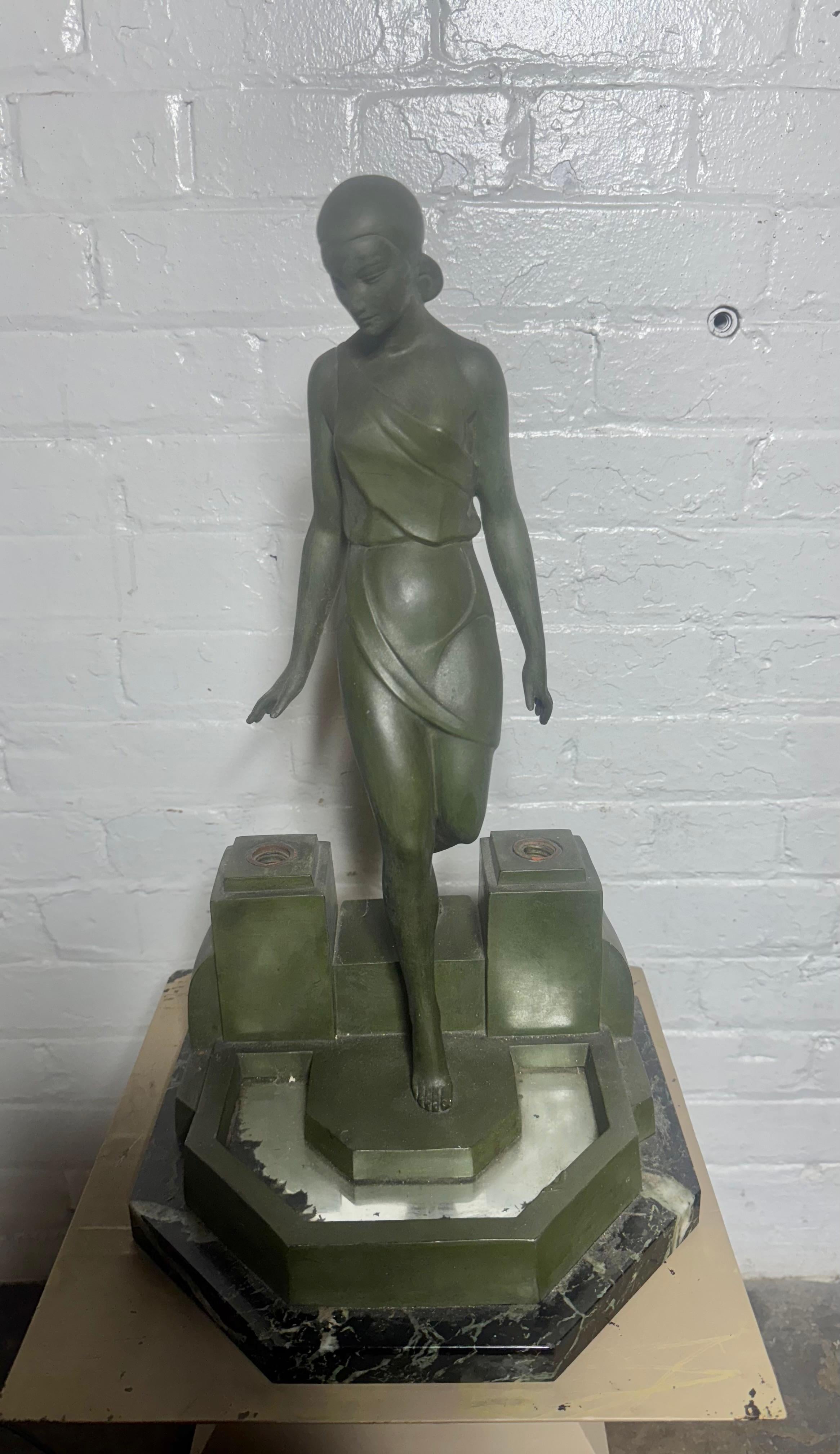 Nausicaa, Art Deco style lamp lady at a fountain.
Signed Fayral, pseudonym of Pierre Le Faguays.

Design 1930.

Art metal, patinated. Wonderful original patina , color , finish... Missing Frosted crackle glass shades.(see photos) Replacement shades