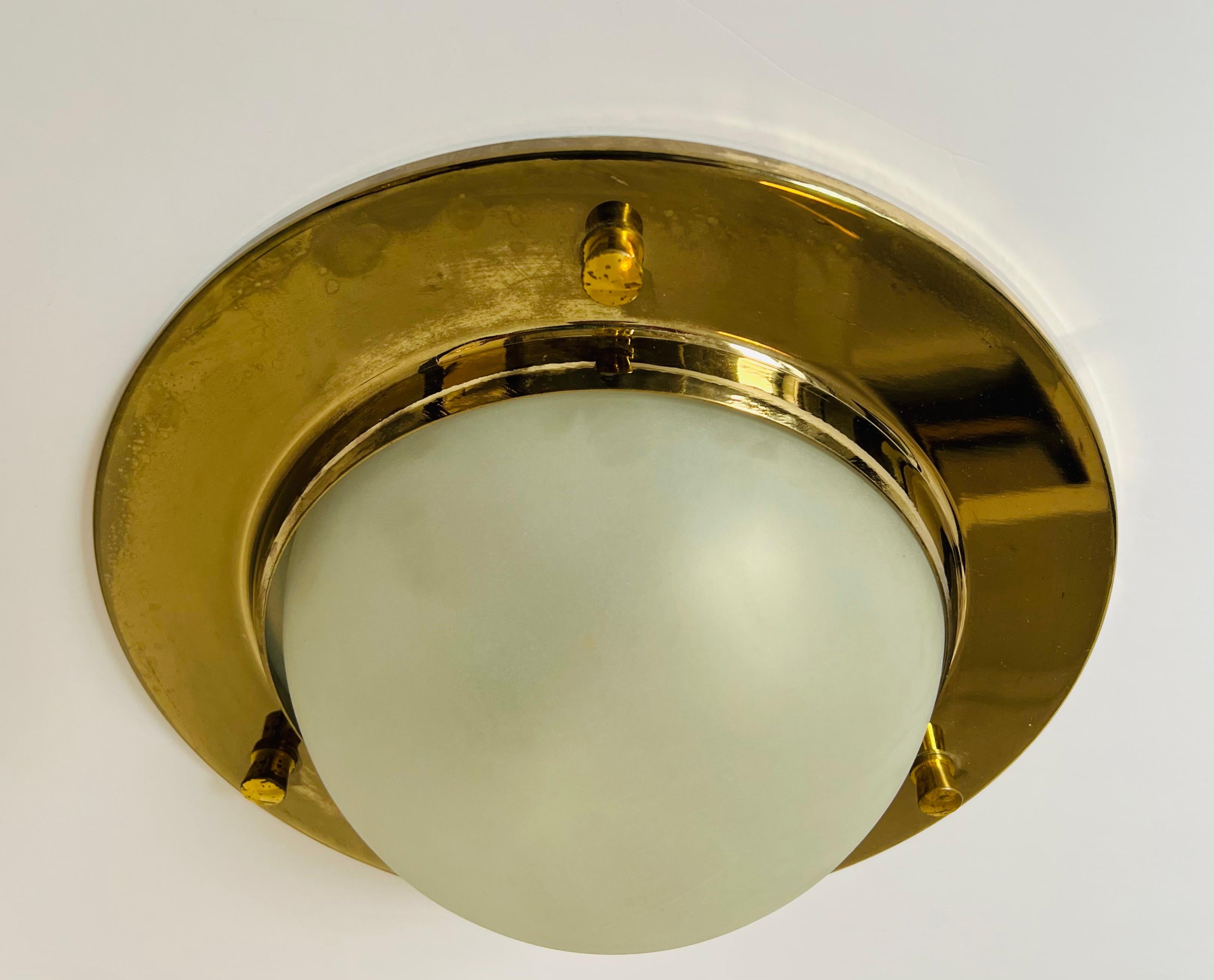 A wonderful Nautical style aged polished brass flush light with a frosted glass dome shade by Italian maker, Azucena. Rewired.