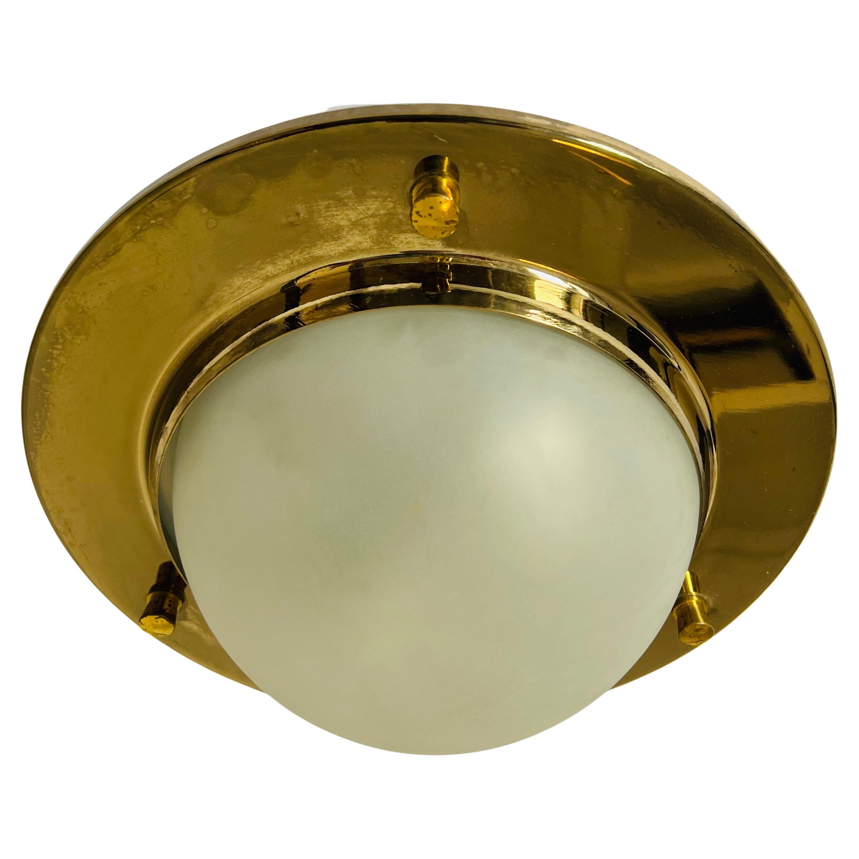 A wonderful Nautical style aged polished brass flush light with a frosted glass dome shade by Italian maker, Azucena. Rewired.