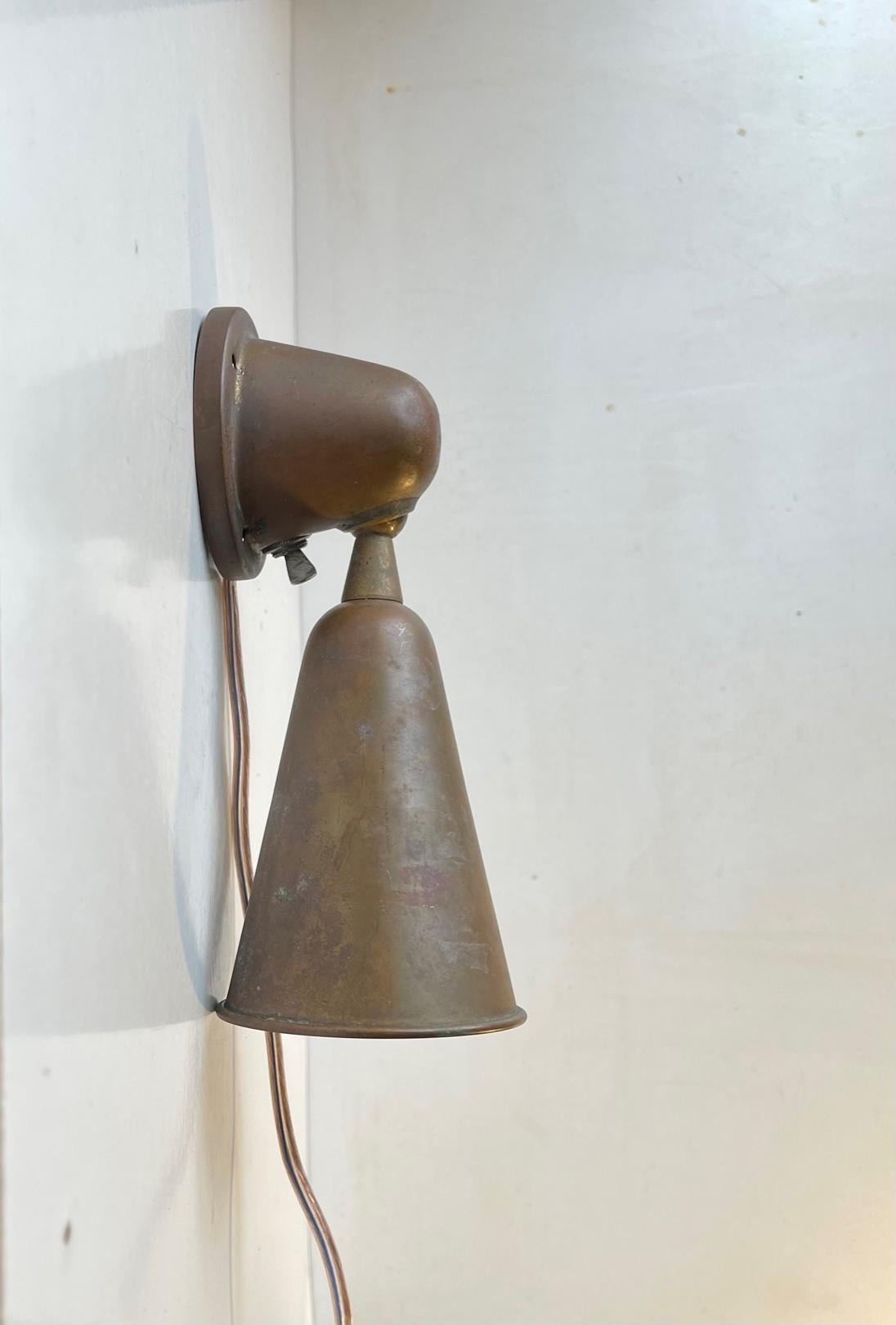 Unusual ball-bearing adjustable wall light in patinated copper. Very nautical - Maritime in appearance and according to the collector from whom we bought it was salvaged from a 1930s French or Italian Submarine. It certainly has this raw authentic