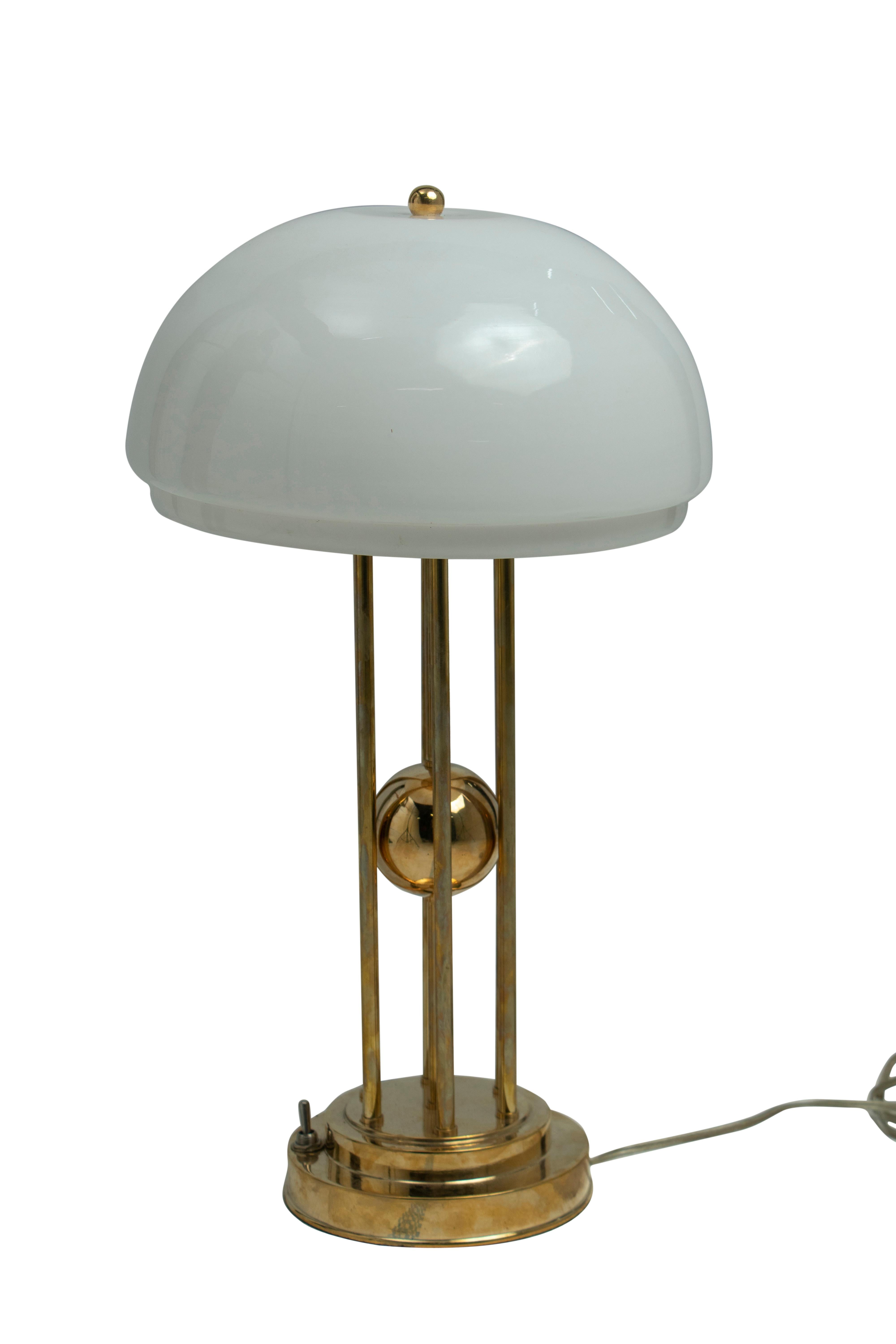 A pair of brass tables lamps from the stateroom of a decommissioned ship from the 1970's.  A frosted glass domed shade and the light takes a standard base light bulb.  The brass base measures 6.5