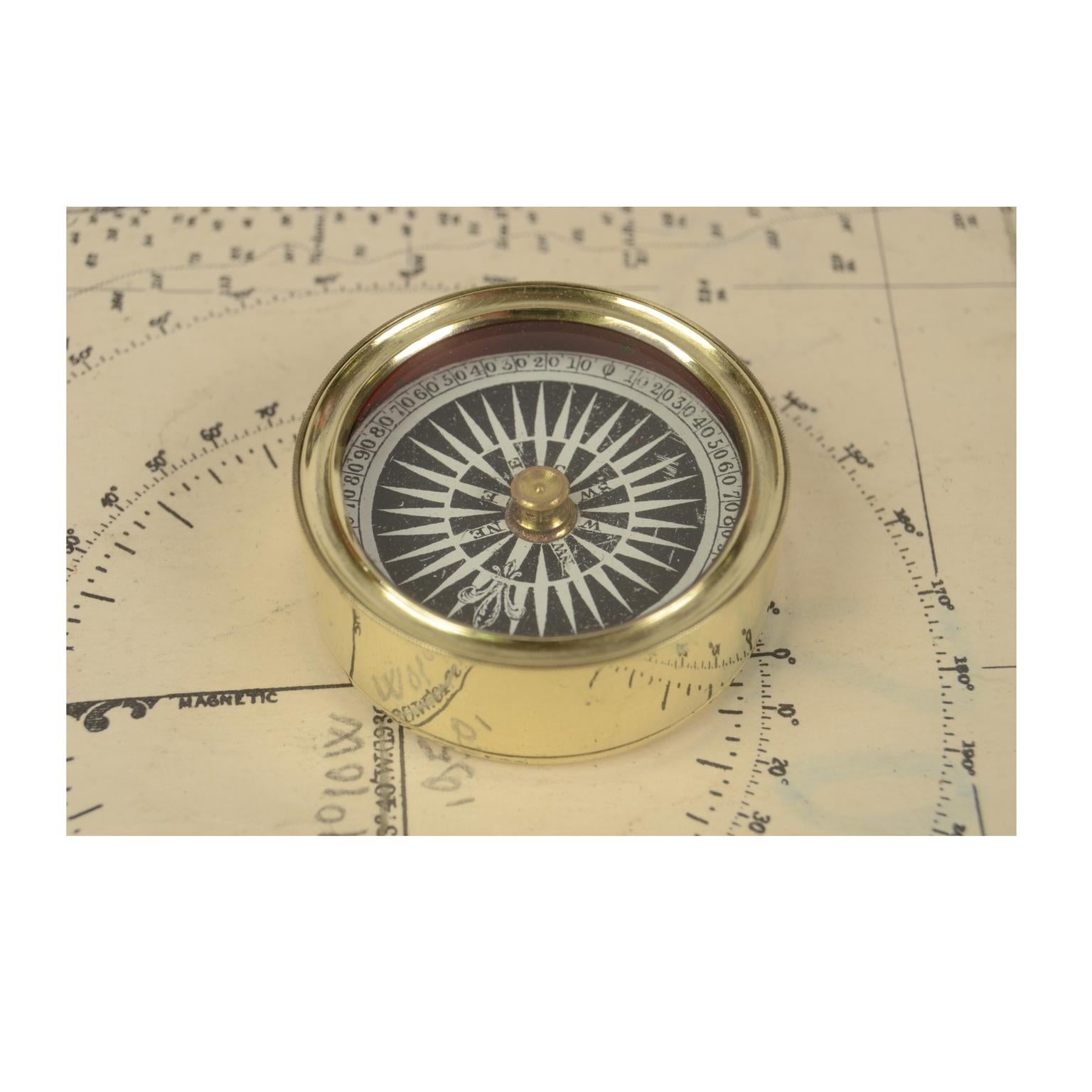 Small pocket nautical compass in its original turned brass case on the bottom of which is fixed a metal stem on which the compass card with sixteen winds printed by engraved on copper plate is placed, complete with goniometric circle. English