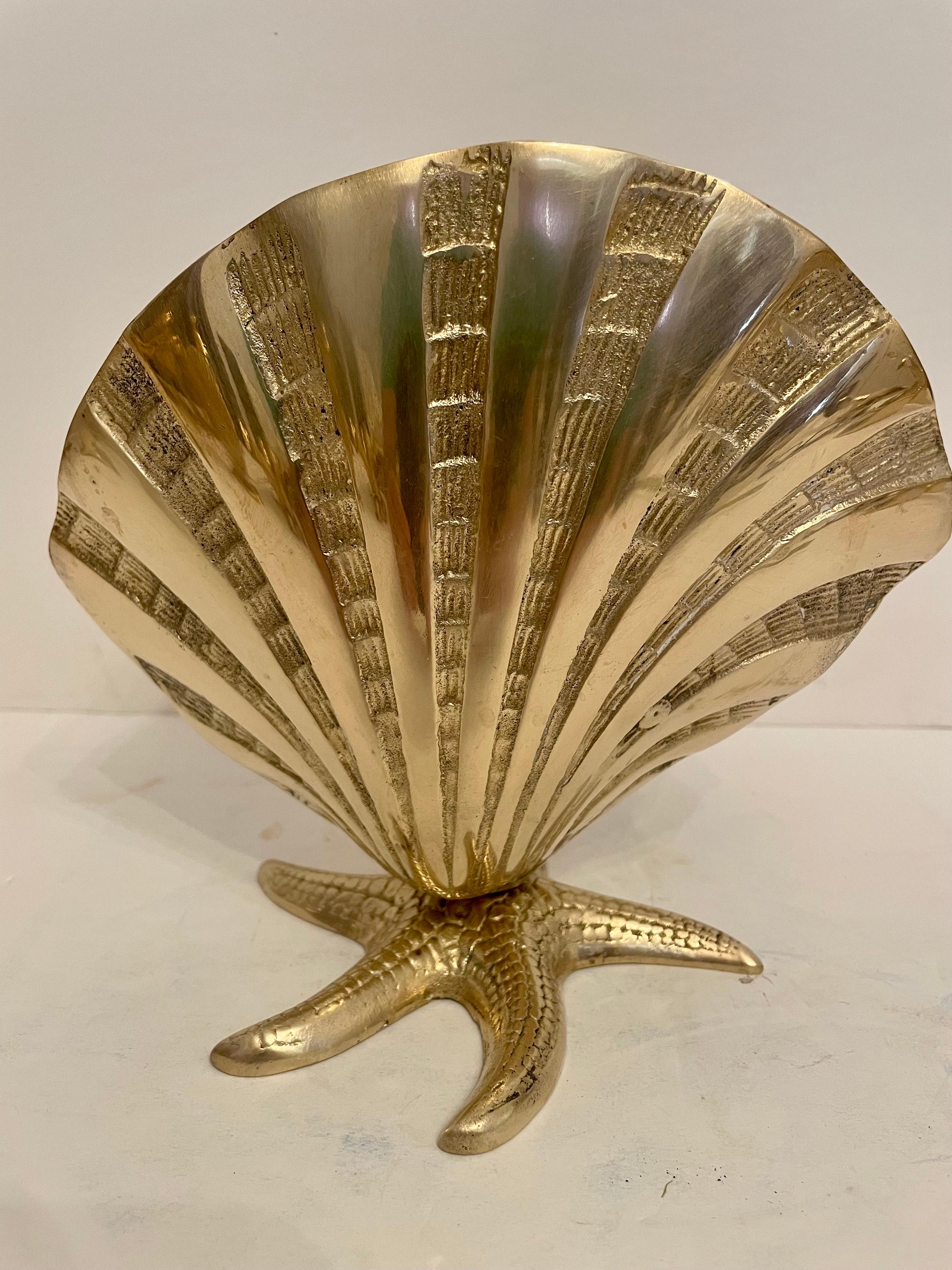 Large brass sea shell planter on starfish base. Very unusual design with nice detail. nice hand polished finish. some patina spots inside, but overall nice condition. Ready for your beach house!