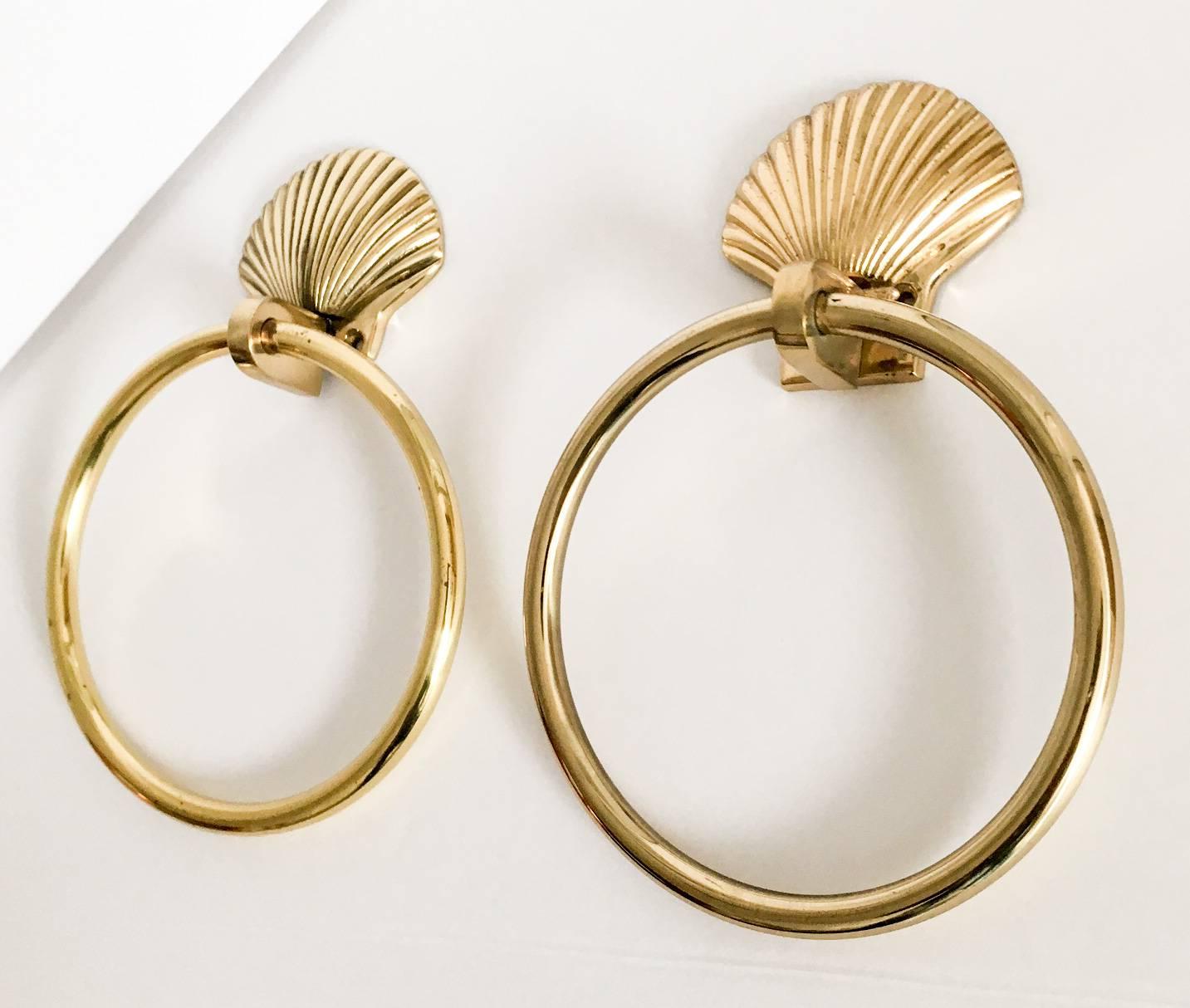 Handsome pair of nautical style brass guest towel rings. The shell mounts are solid brass and the rings are tubular hollow brass. Ring inside dimension, 5