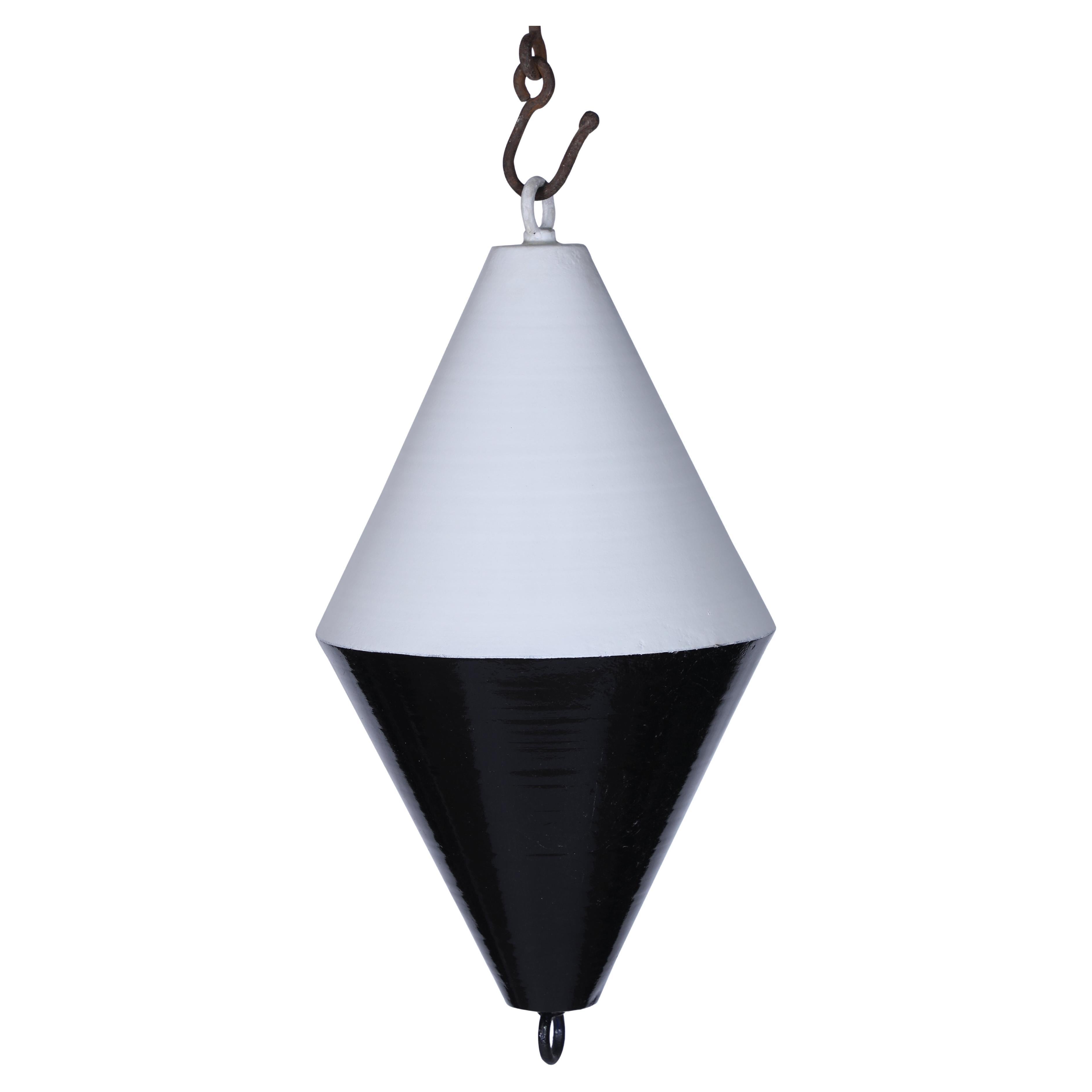 A ship's metal day shape signal buoy from the 1970's.  This is a diamond shape with one end black and the other white.  As most signal buoys are black, perhaps this indicates a cone shape which when mounted aloft the ship would indicate under sail