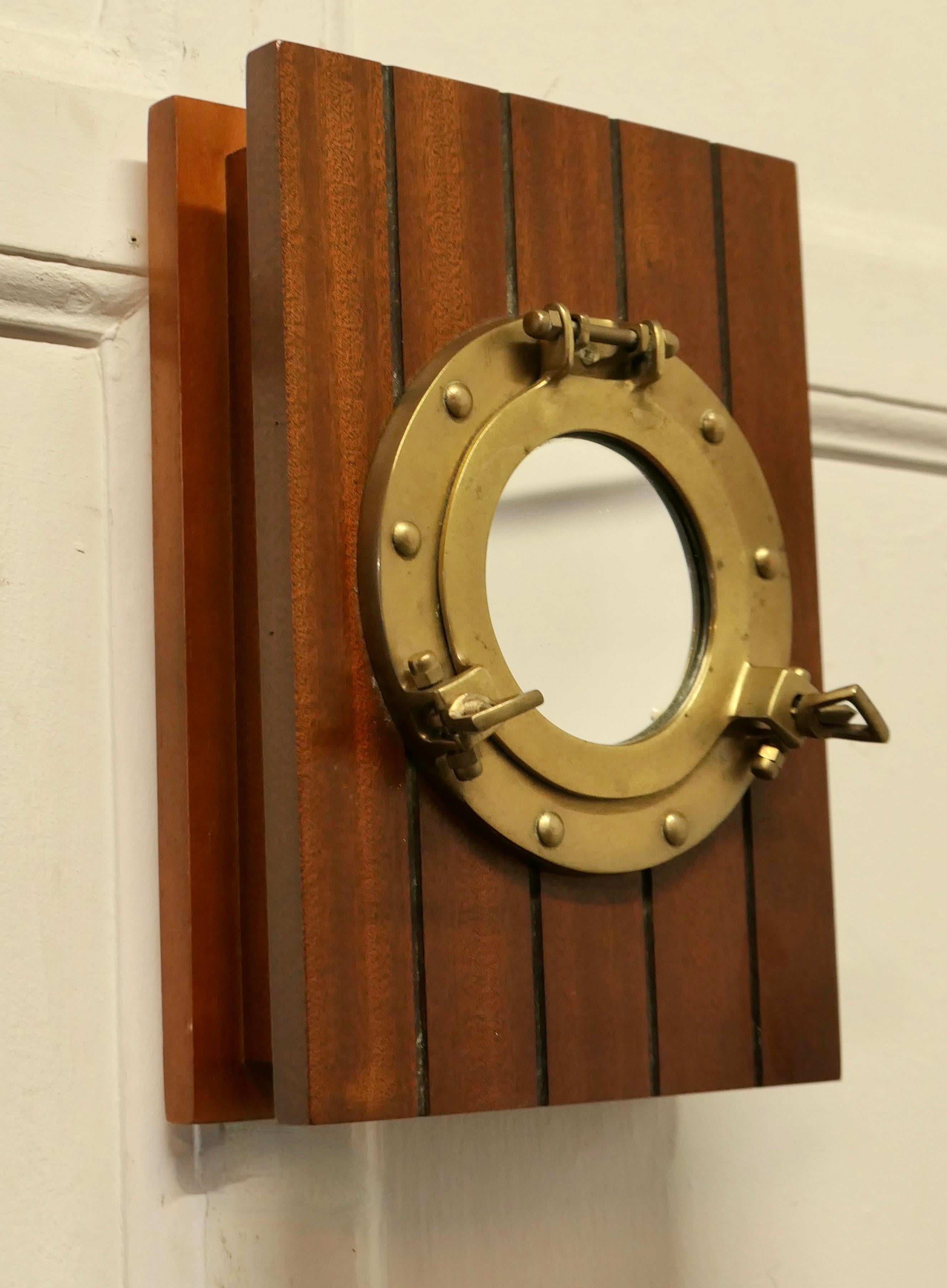 Nautical Design Hotel Reception Key Cupboard  

This is a Solid Teak Key cupboard with a mirrored brass porthole on the front of the door. The cupboard has 5 key hooks inside and there is room for more if needed
The cupboard is in good condition, it