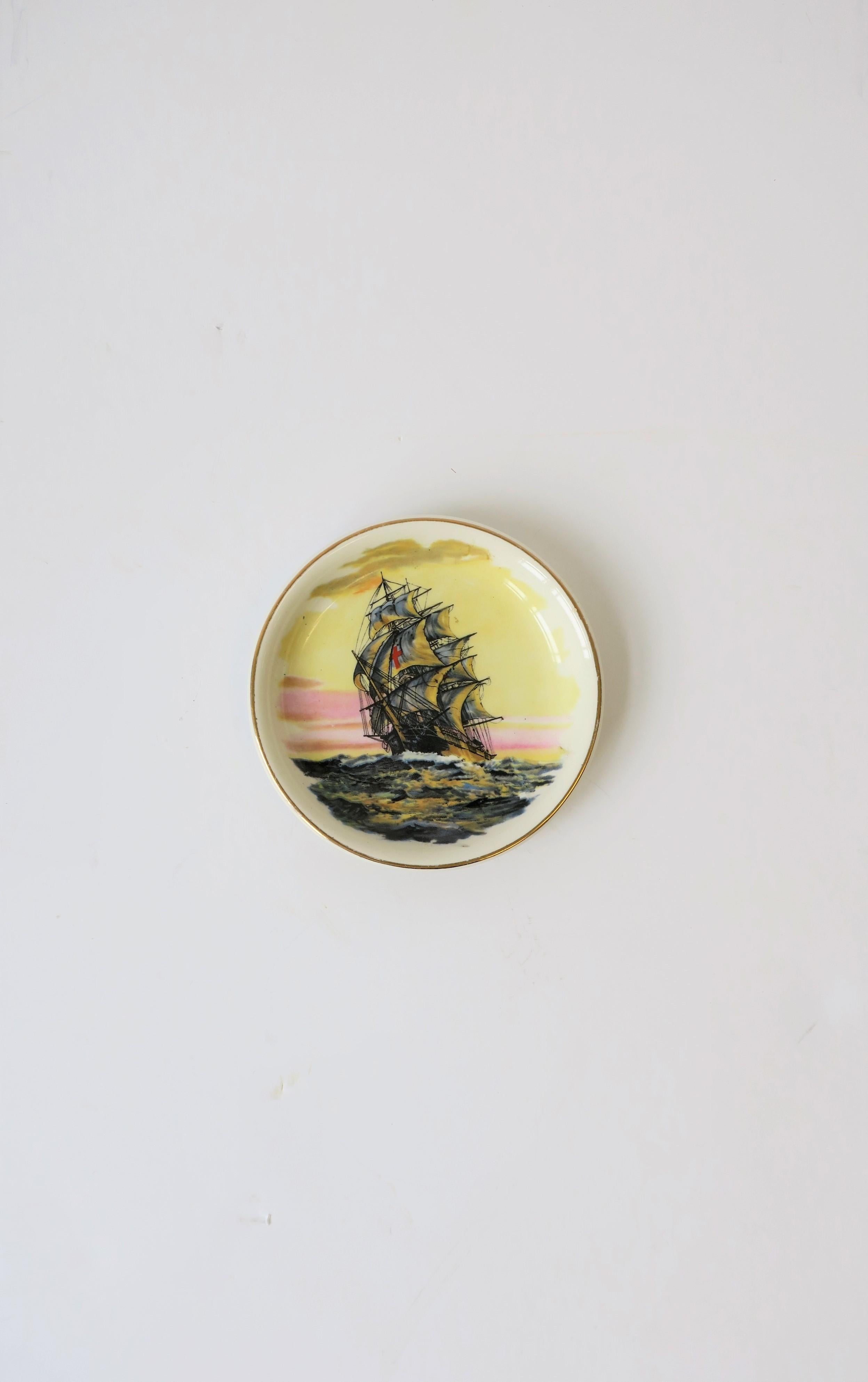 A small round English jewelry or trinket dish with a nautical 'Red Cross' clipper ship design, circa 20th century, England. With makers mark on bottom as show in image #8. A beautiful maritime scene with a 'Red Cross' ship at sea, with detailed