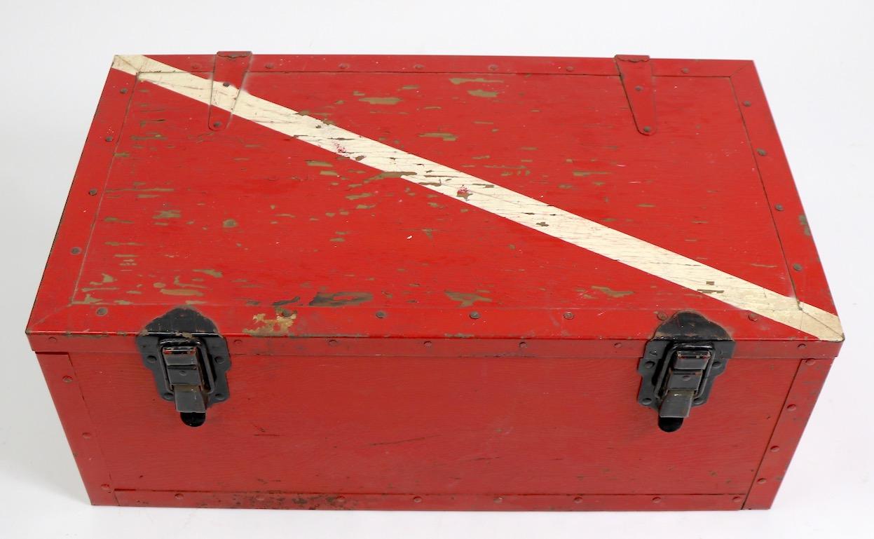 Great bold graphic paint decorated Folk Art wood box, probably originally a signal flag storage box. Red ground with white diagonal stripe across the lid, black metal fitments, and green interior.
 