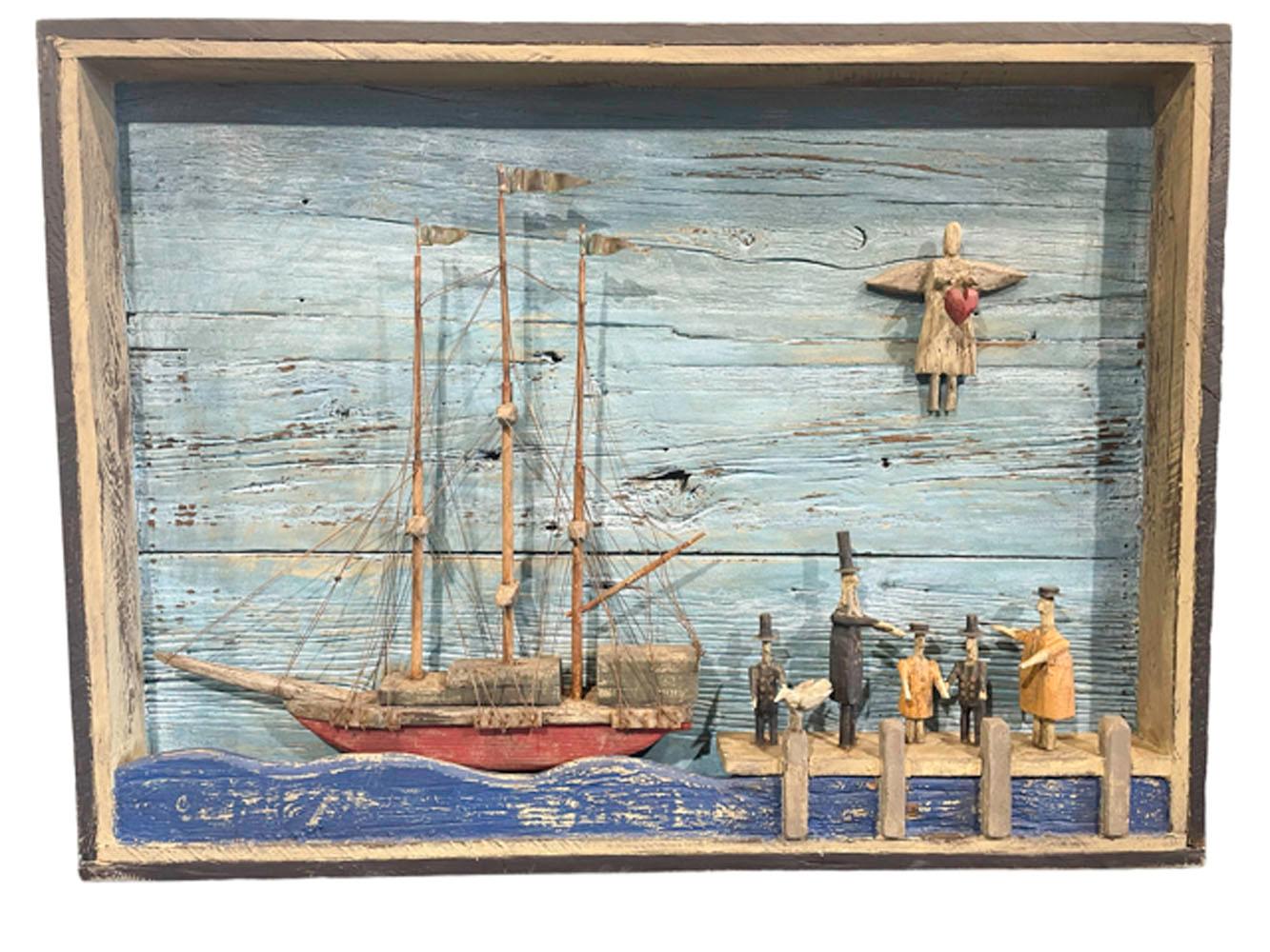 Large contemporary nautical themed folk art diorama depicting a ship at dock with a family gathered on the pier wishing the captain a 'Heartfelt Goodbye' against a clear blue sky where an angel holding a heart appears above the family. Designed and