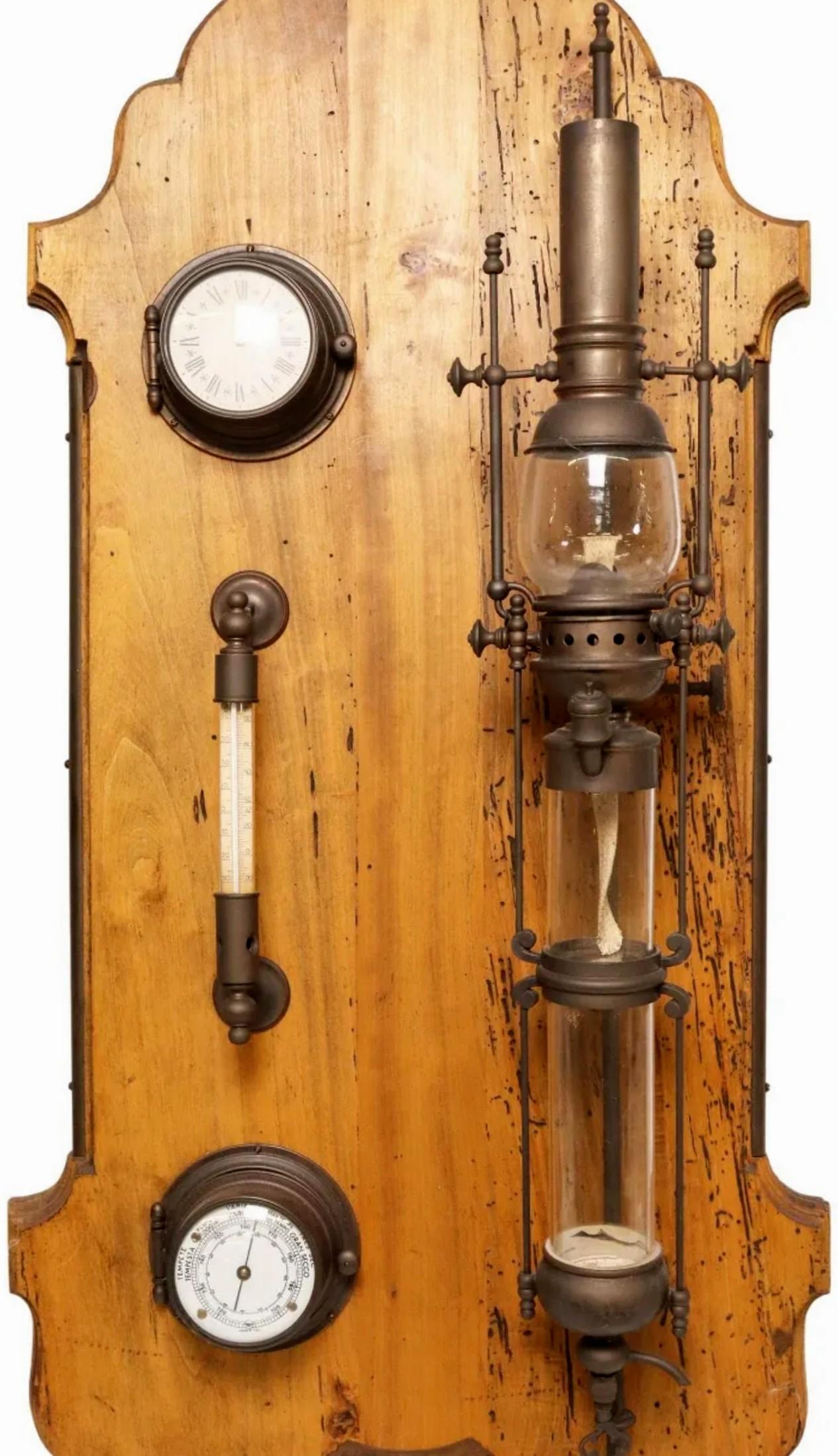 A decorative frigate warship lantern, thermometer, and barometer, mounted on a shaped wood back board, with later metal plaque engraved HMS Lydia.

This unique one-of-a-kind sculptural wall object is sure to add a touch of sophisticated antique